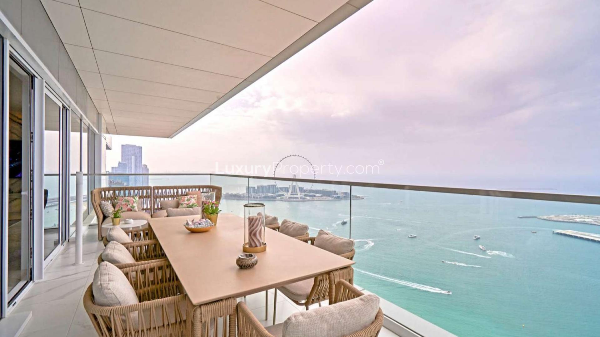 Penthouse balcony view at night, overlooking Jumeirah Beach Residence and Dubai skyline