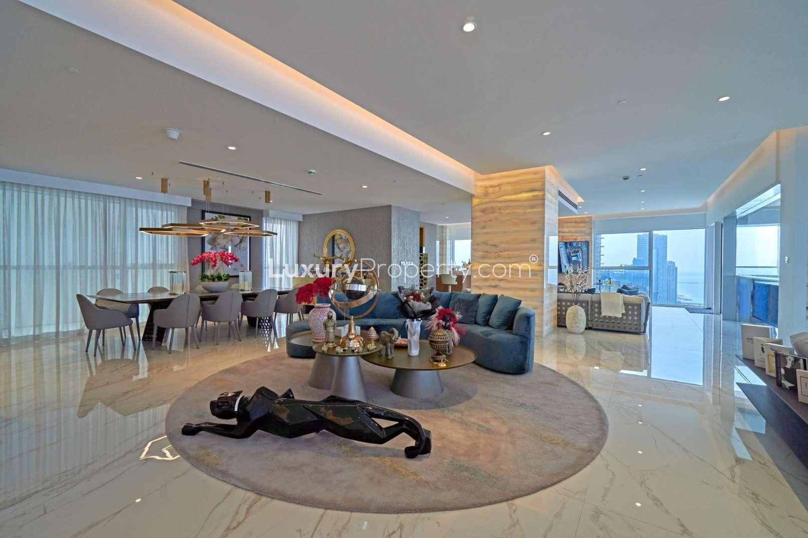 "Spacious penthouse balcony with stunning ocean view in Jumeirah Beach Residence, 1 JBR.",Luxurious living area in beachfront penthouse, Jumeirah Beach Residence, modern decor, ocean view