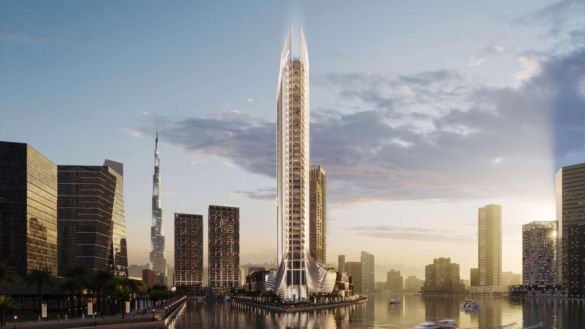 Luxurious penthouse living room with modern decor, spiral staircase, and waterfront view in Business Bay