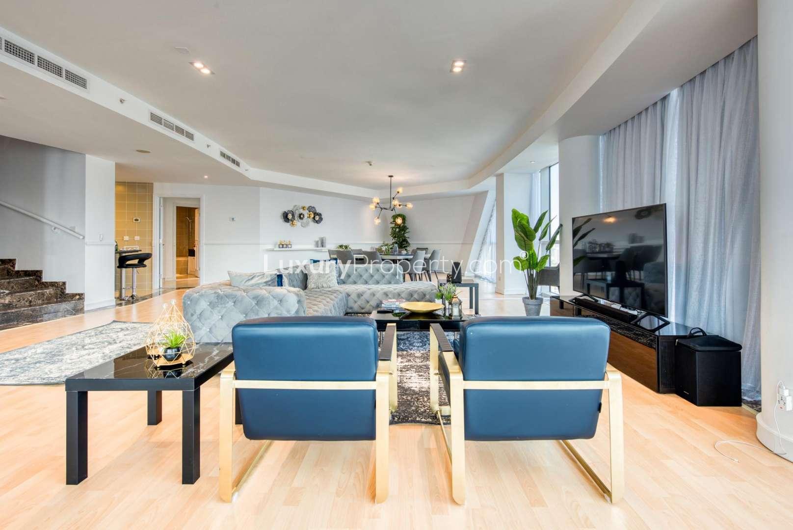 Luxury living room in 5-bedroom penthouse, Dubai Marina, with modern decor and spacious layout