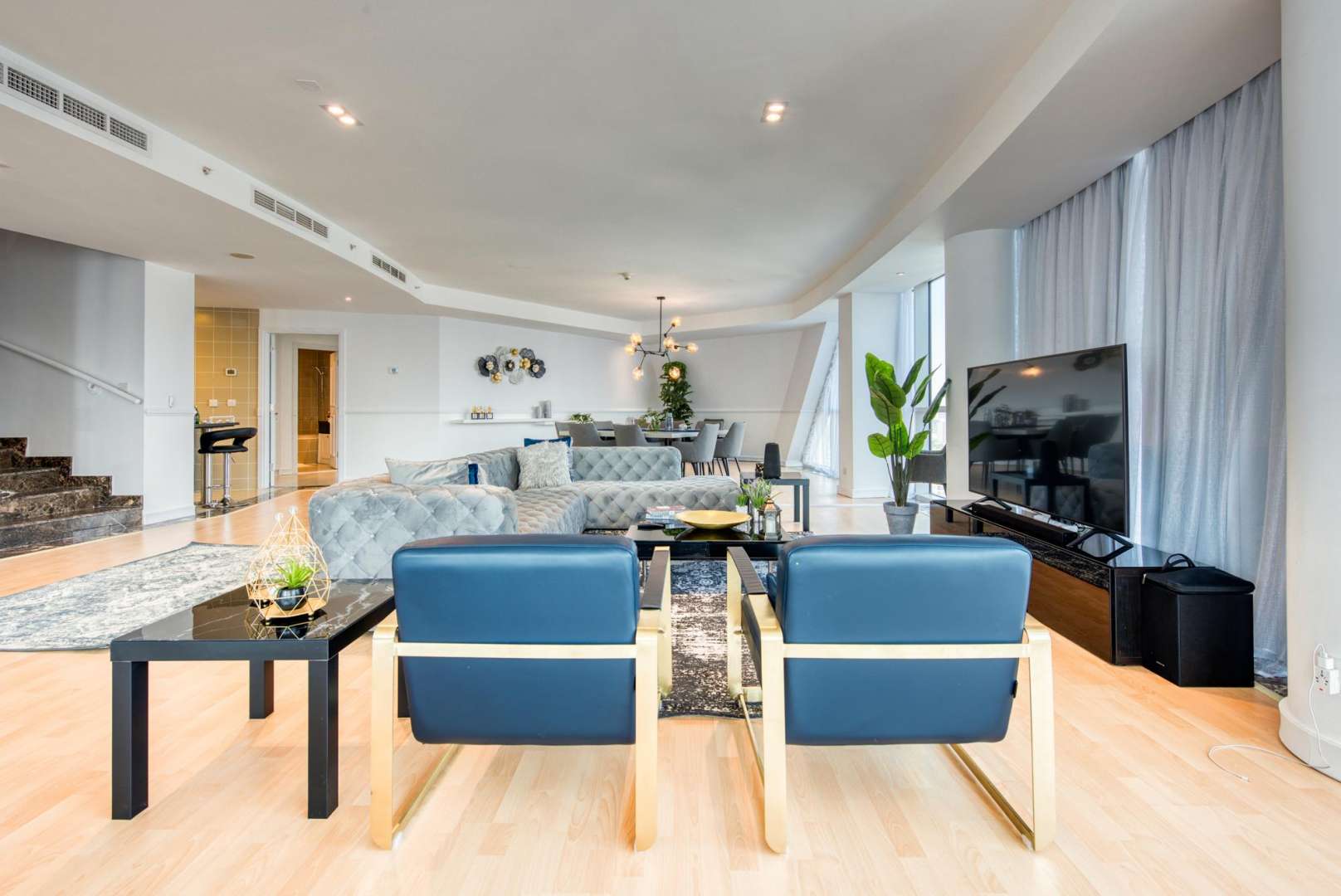 Luxury living room in 5-bedroom penthouse, Dubai Marina, with modern decor and spacious layout