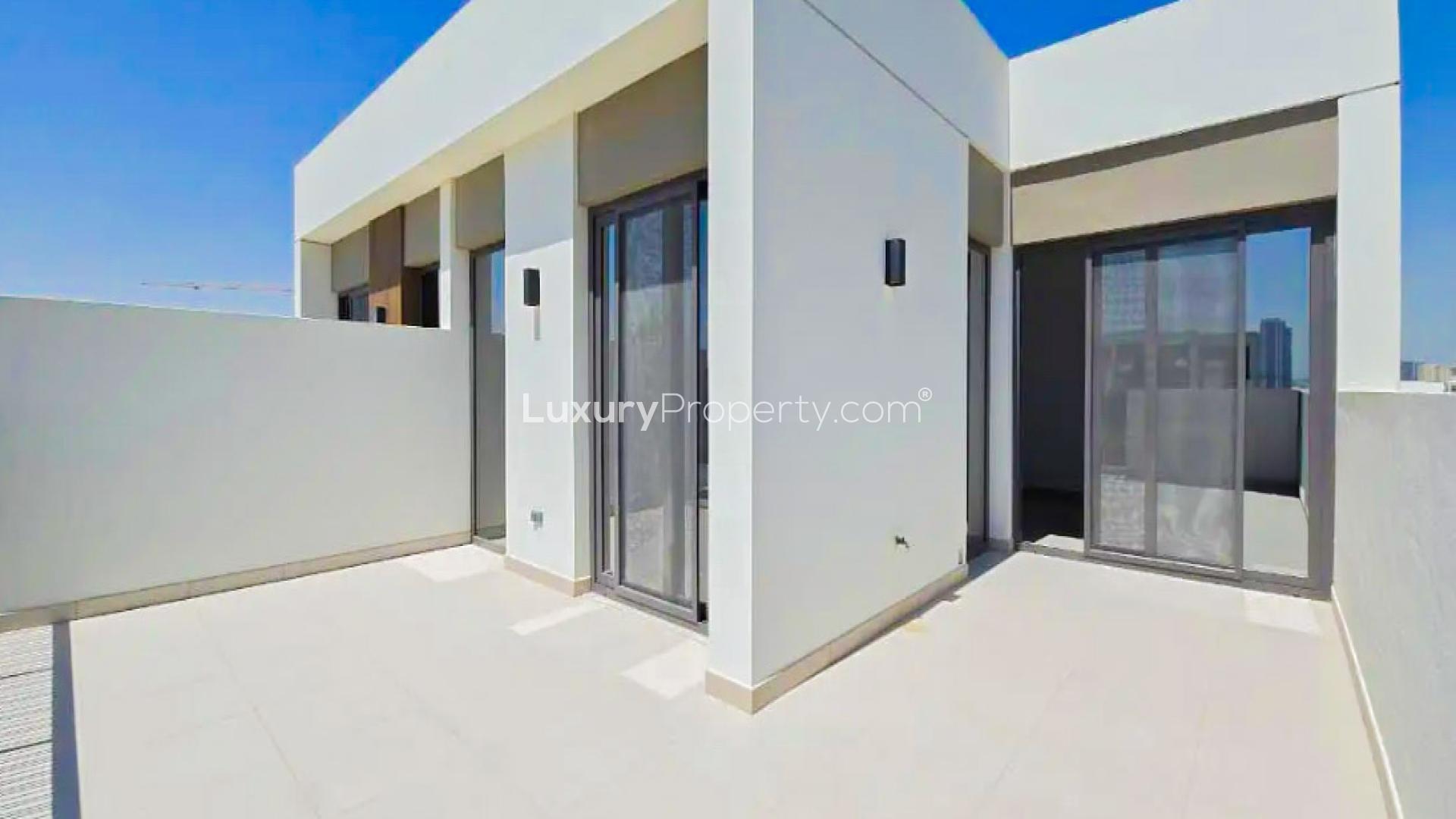 Bright living area with large windows in Tilal Al Ghaf townhouse for rent