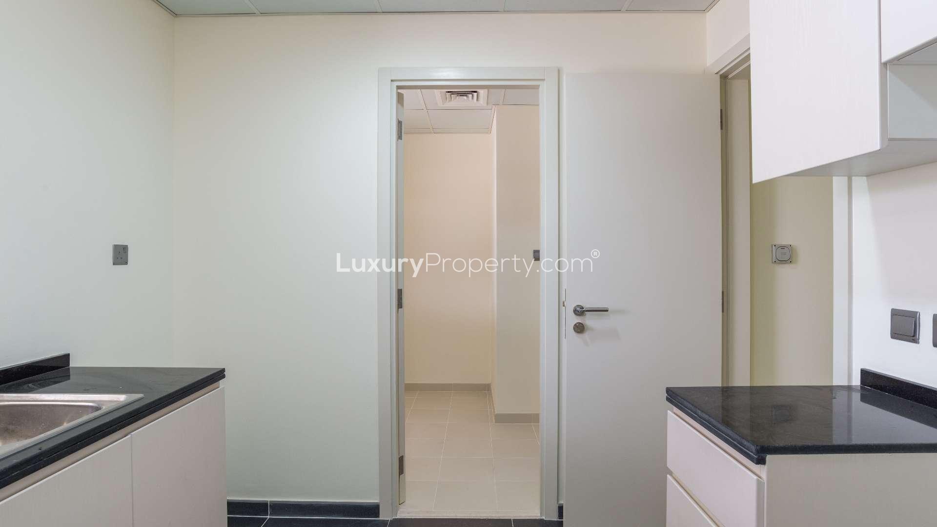 Modern kitchen in five-bedroom townhouse, Aster, Damac Hills 2, with sleek countertops and cabinetry