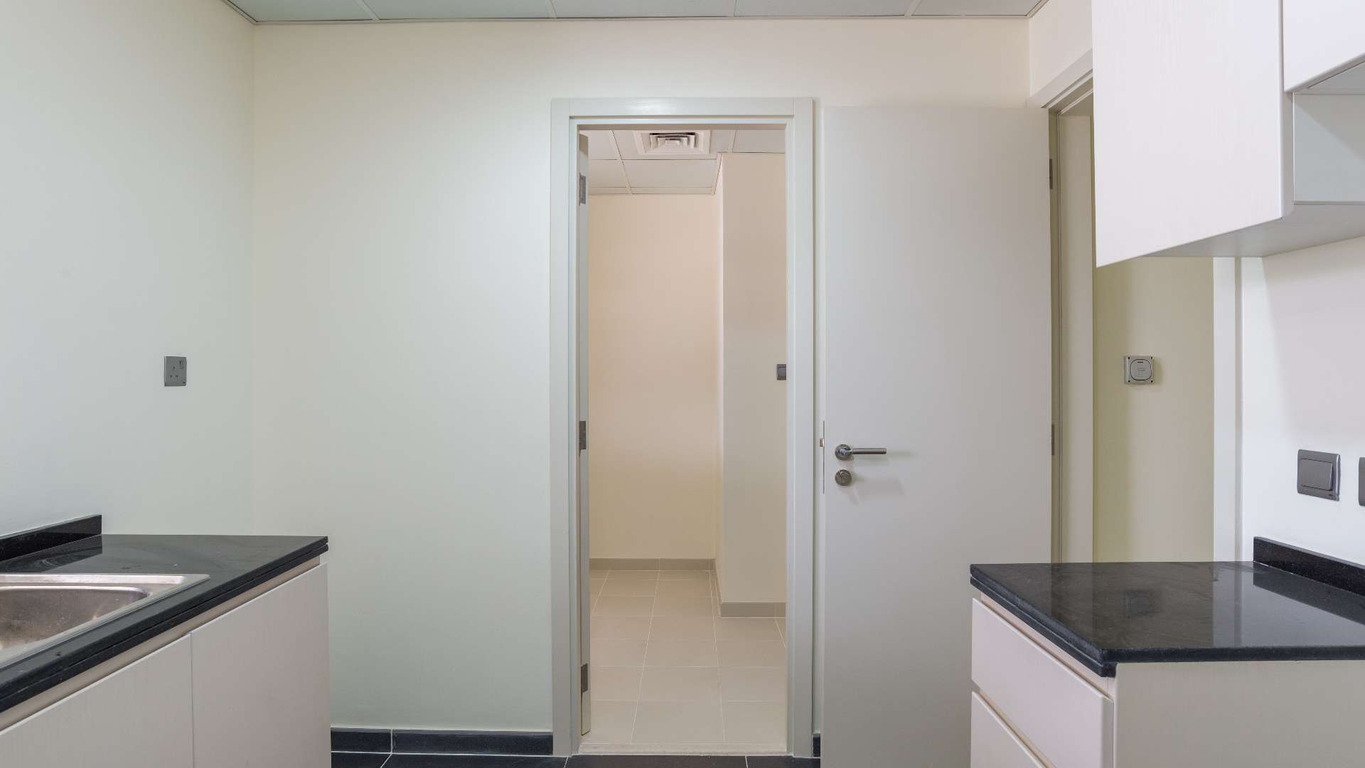 Modern kitchen in five-bedroom townhouse, Aster, Damac Hills 2, with sleek countertops and cabinetry