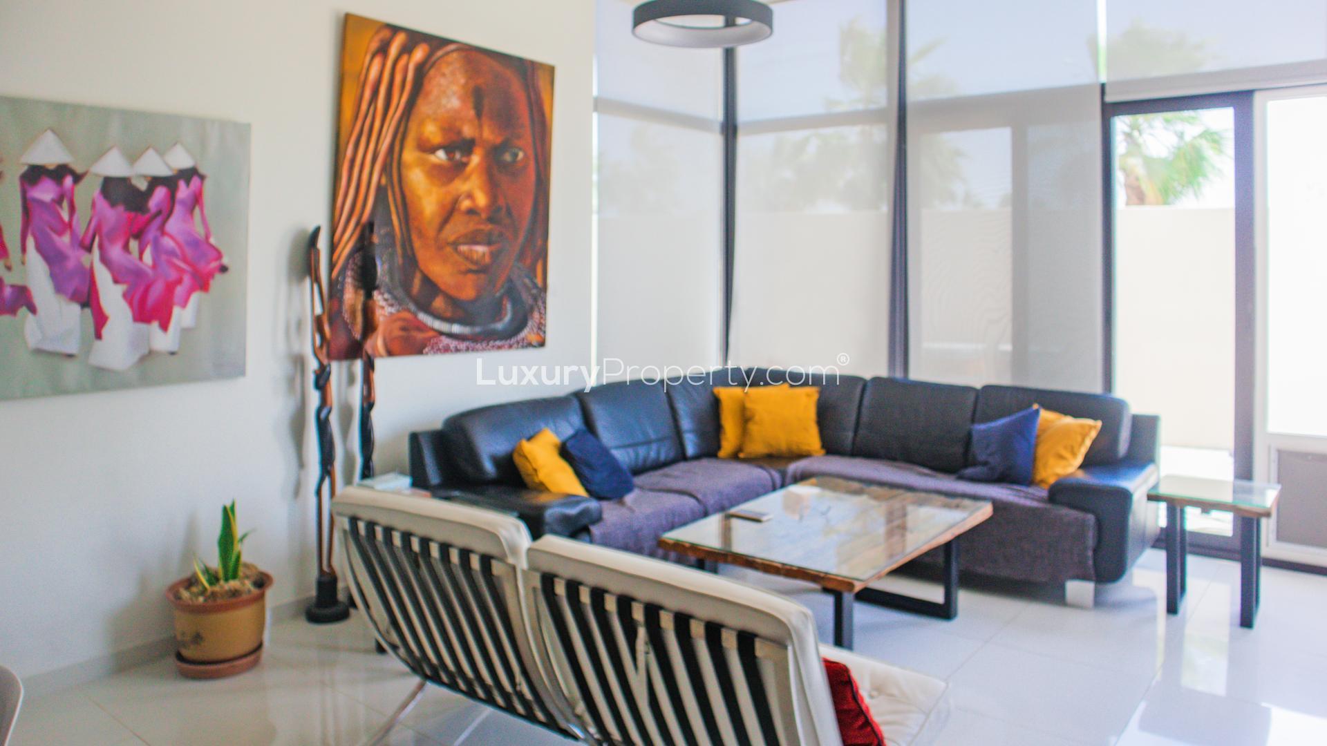 Balcony view of Damac Hills townhouse in Brookfield, featuring outdoor seating and greenery