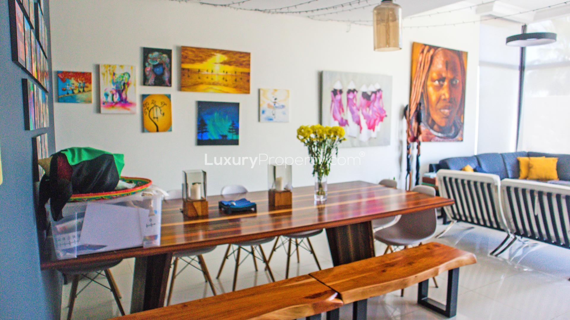 Modern living room in Damac Hills townhouse, featuring large windows and stylish decor