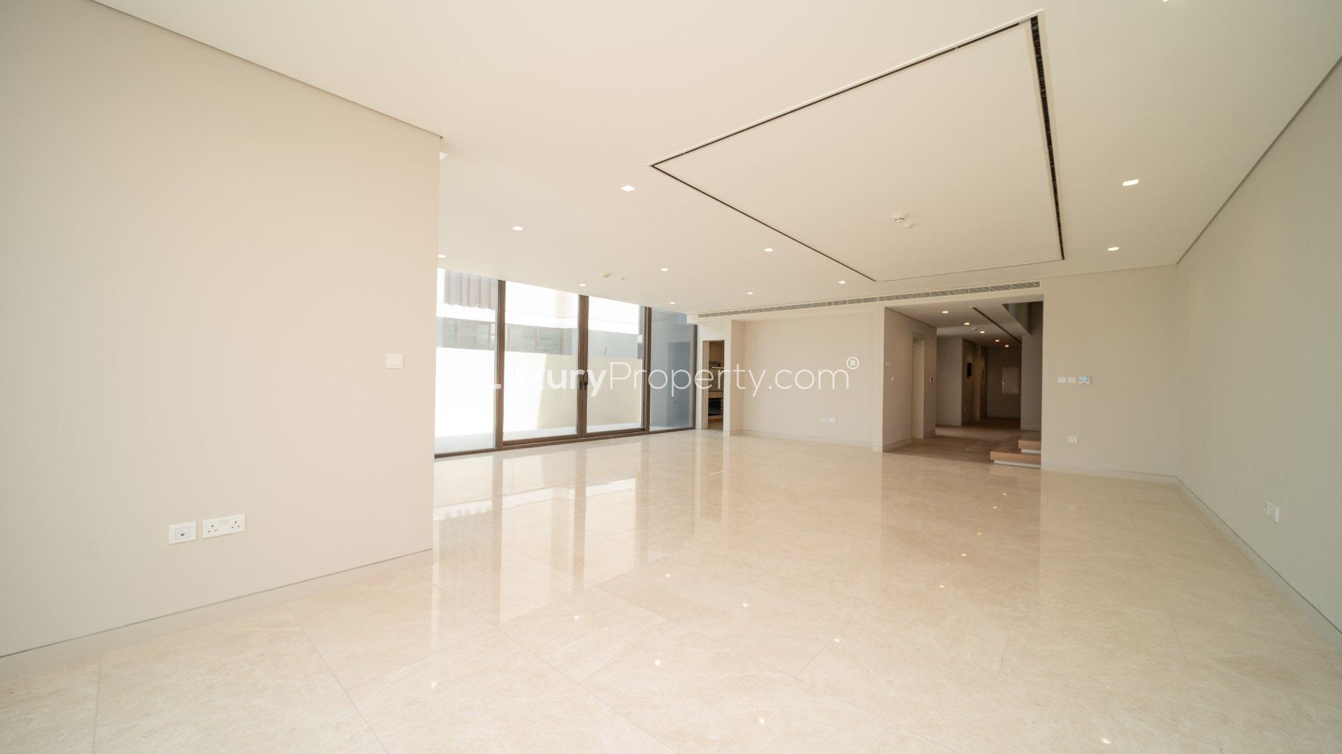 Balcony view of beachfront townhouse on Jumeirah Bay Island, overlooking ocean and sandy shore