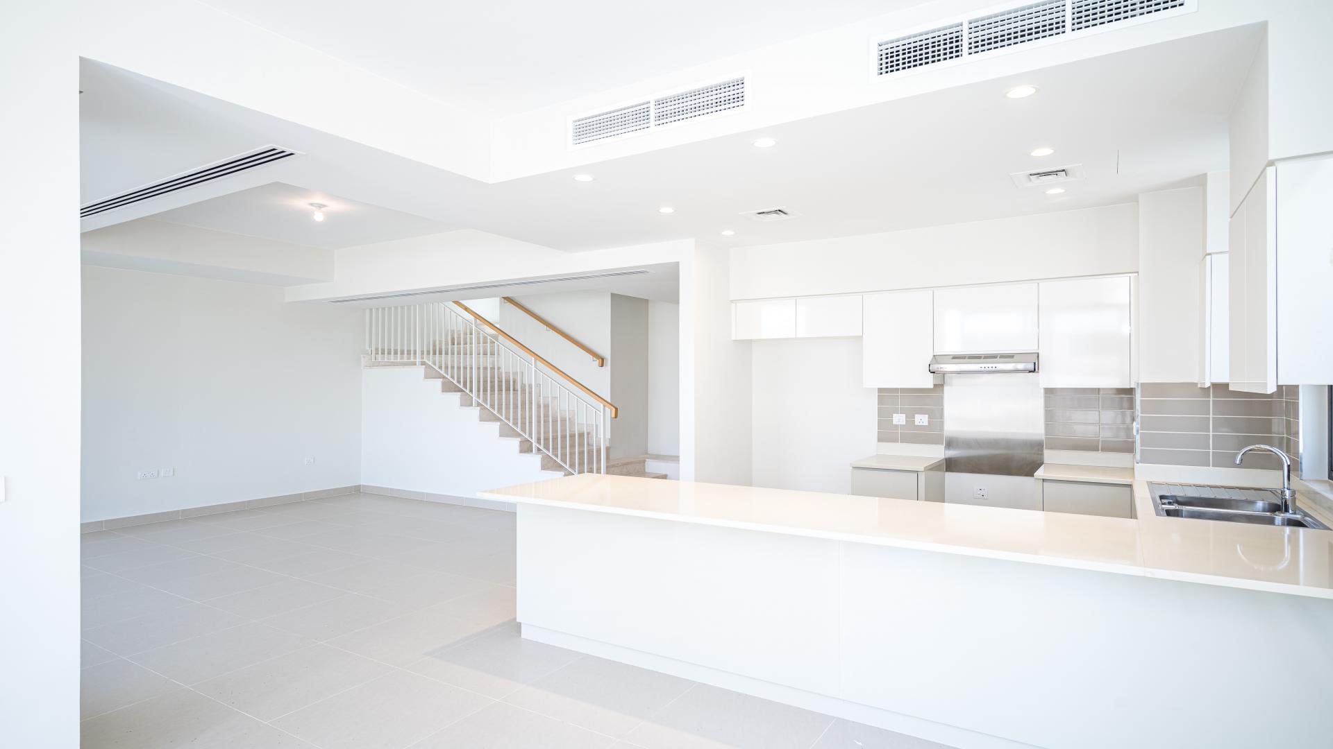 Modern kitchen in Dubai Hills Estate townhouse for rent, featuring sleek white cabinetry