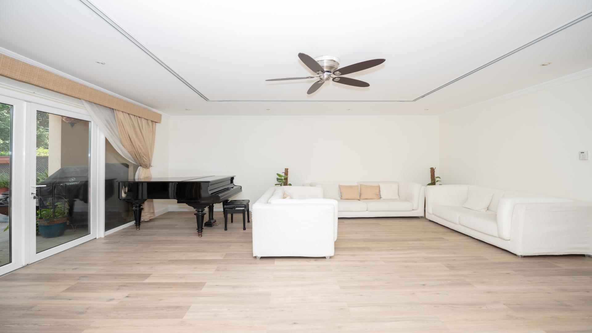 Balcony view from renovated townhouse in Green Community East, overlooking lush greenery and pool
