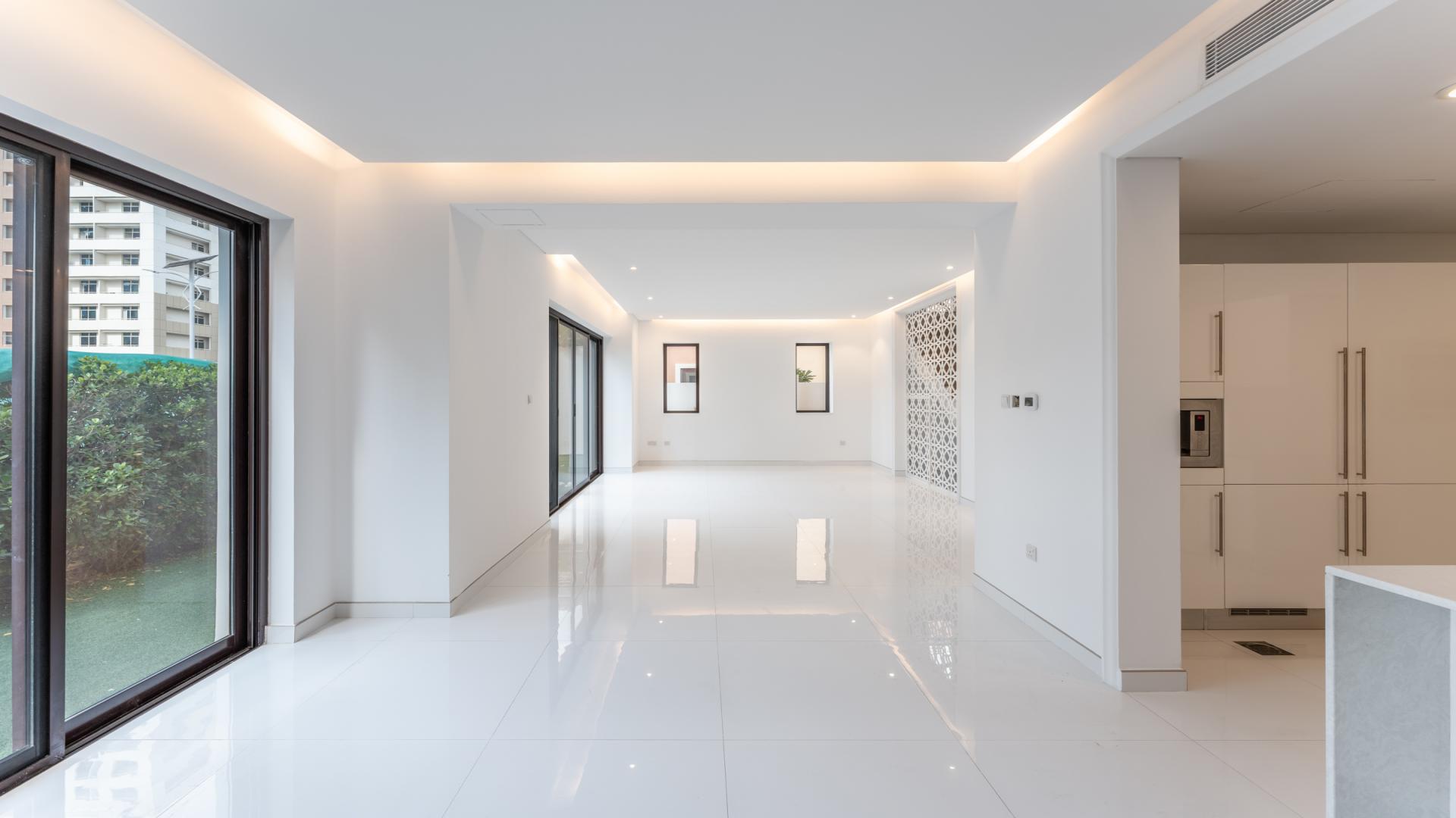 Bright living area with large windows in upgraded Bloomingdale townhouse, Dubai Sports City