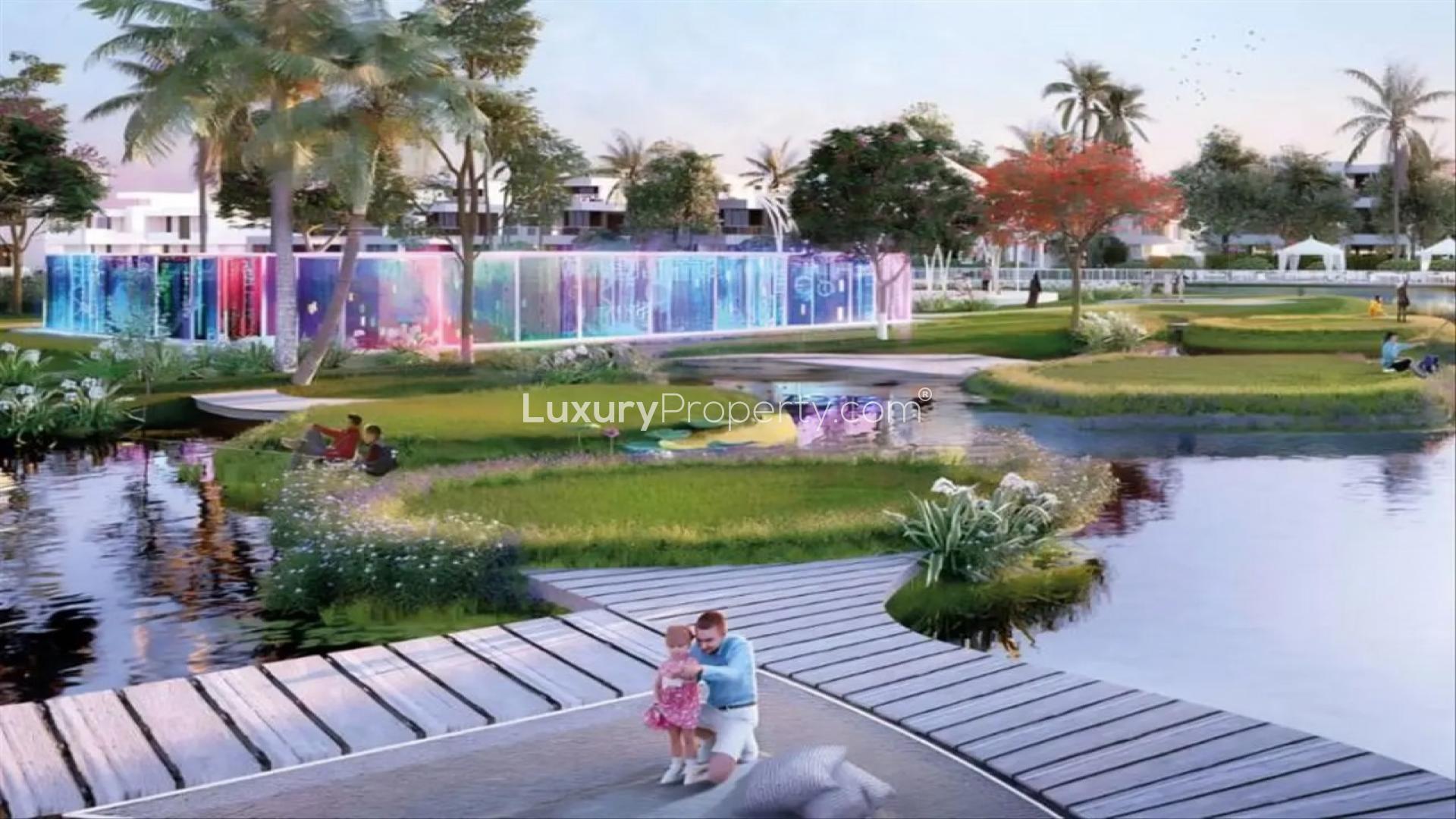 Modern Mediterranean townhouse community with lush gardens and water features in DAMAC Lagoons