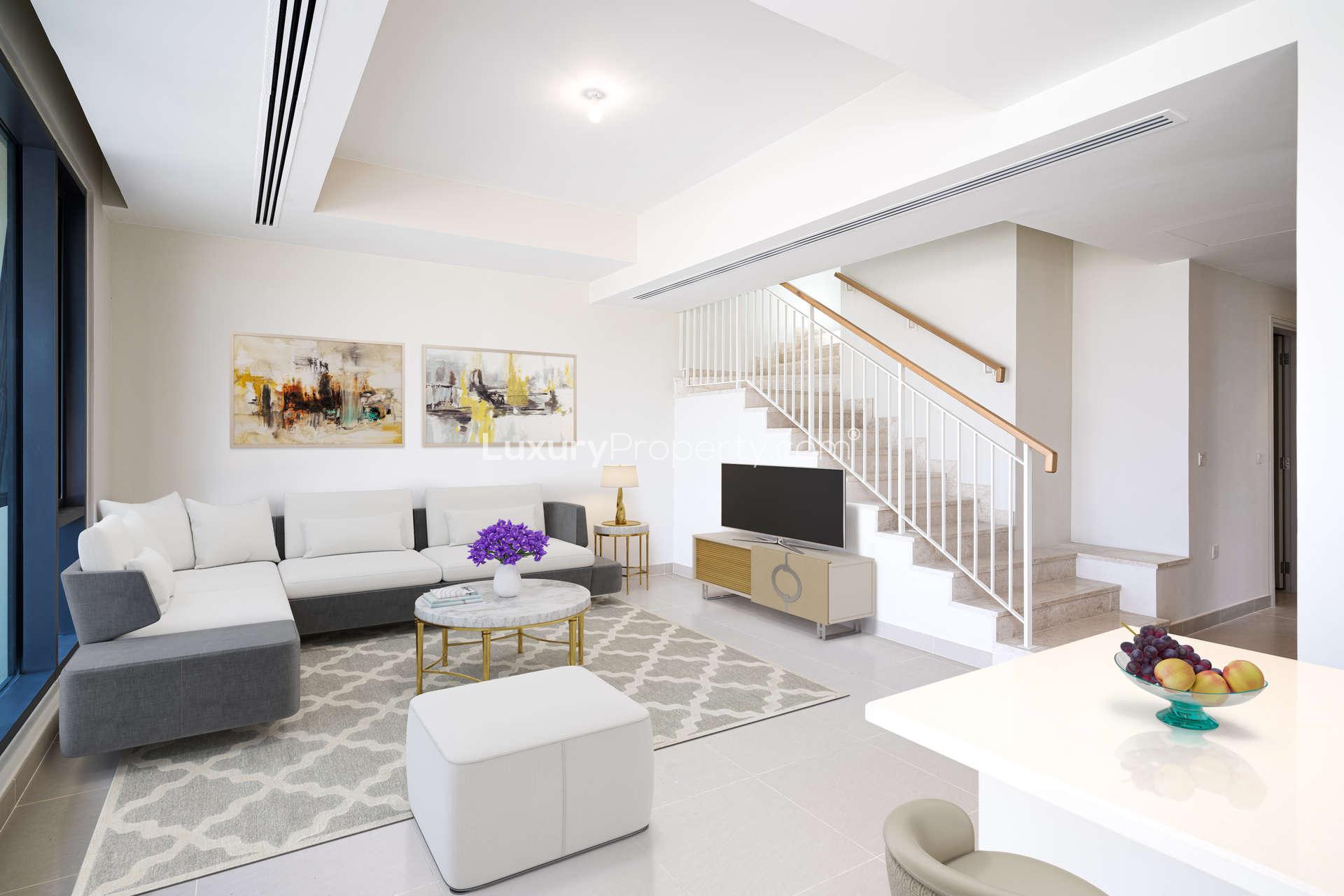 Modern living room in Maple Town House, Dubai Hills Estate, featuring elegant decor and staircase