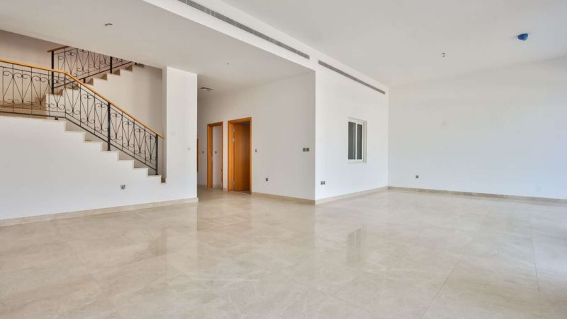 Open-plan living area with staircase in Palma Residences villa, Palm Jumeirah