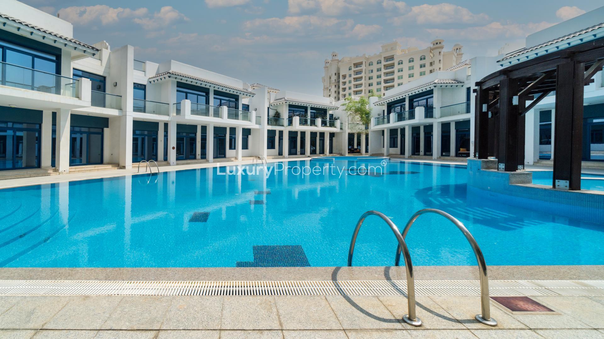 Spacious living area in Palma Residences townhouse, featuring elegant wood flooring and modern lighting