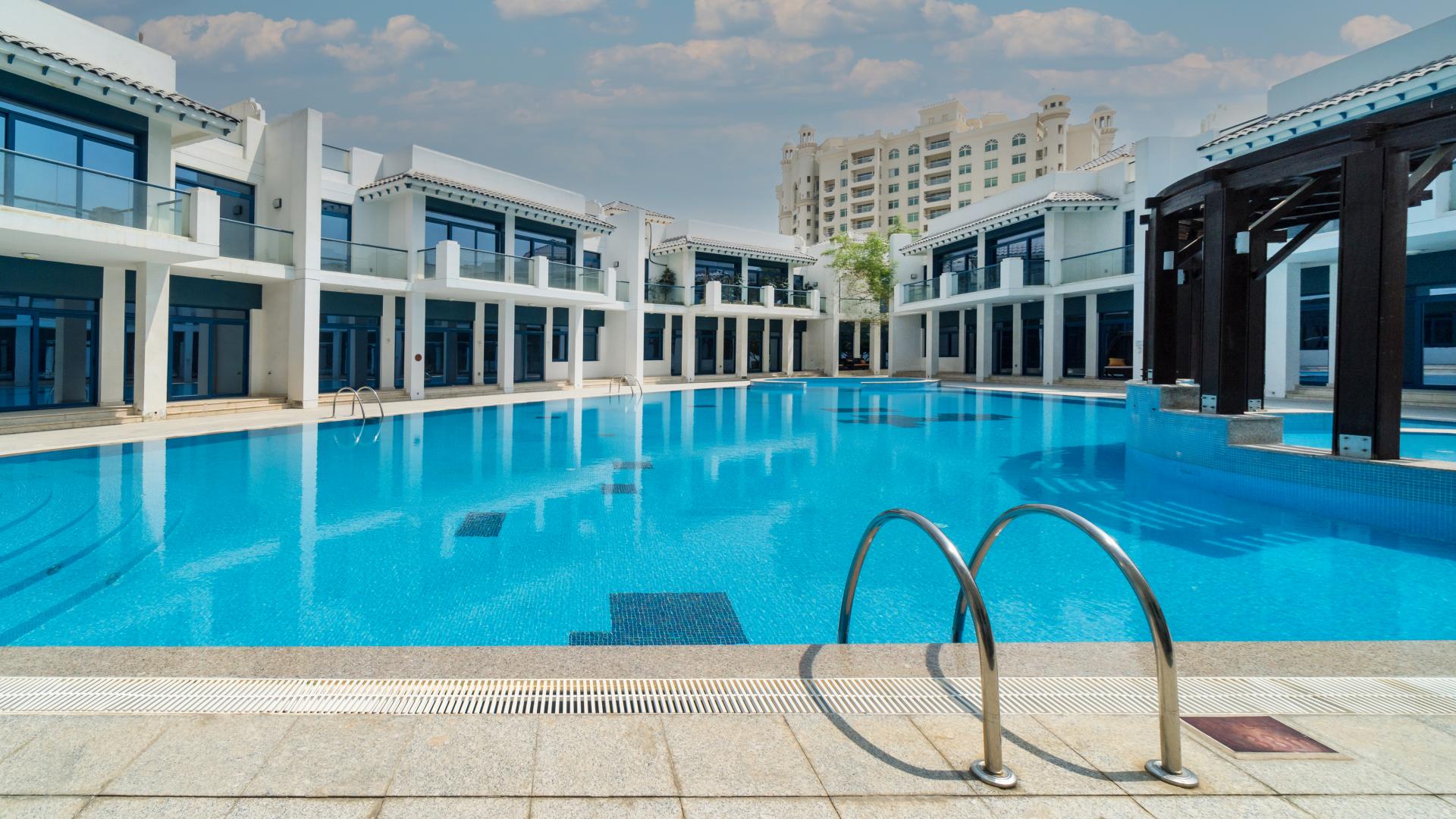 Spacious living area in Palma Residences townhouse, featuring elegant wood flooring and modern lighting