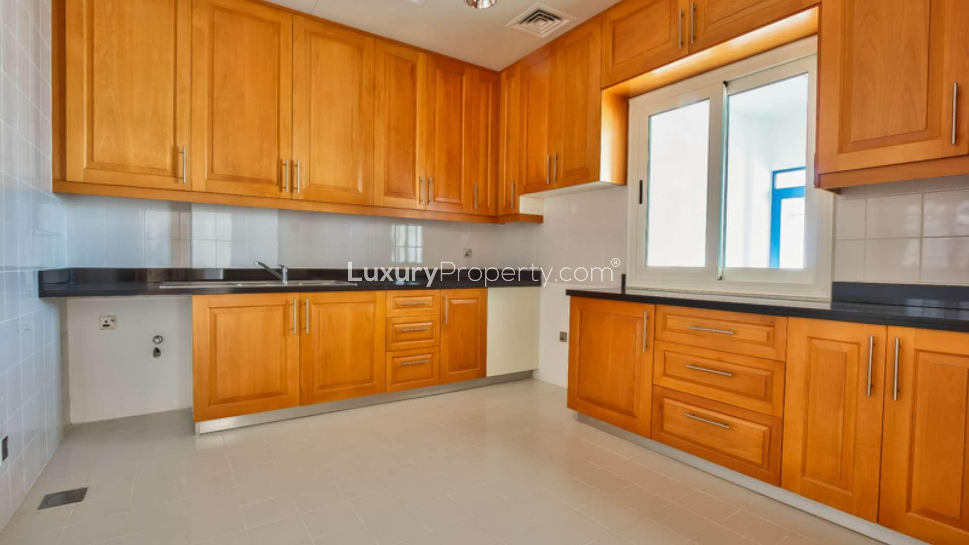 Empty living area in Palma Residences townhouse, featuring elegant staircase and marble flooring