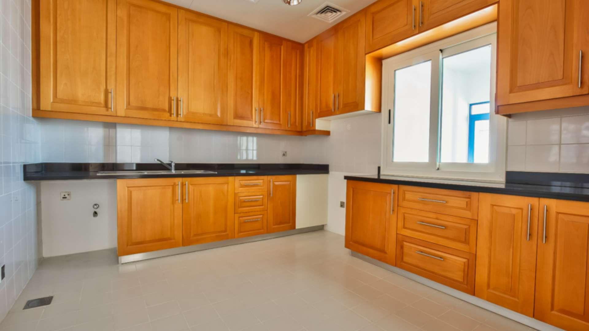 Empty living area in Palma Residences townhouse, featuring elegant staircase and marble flooring