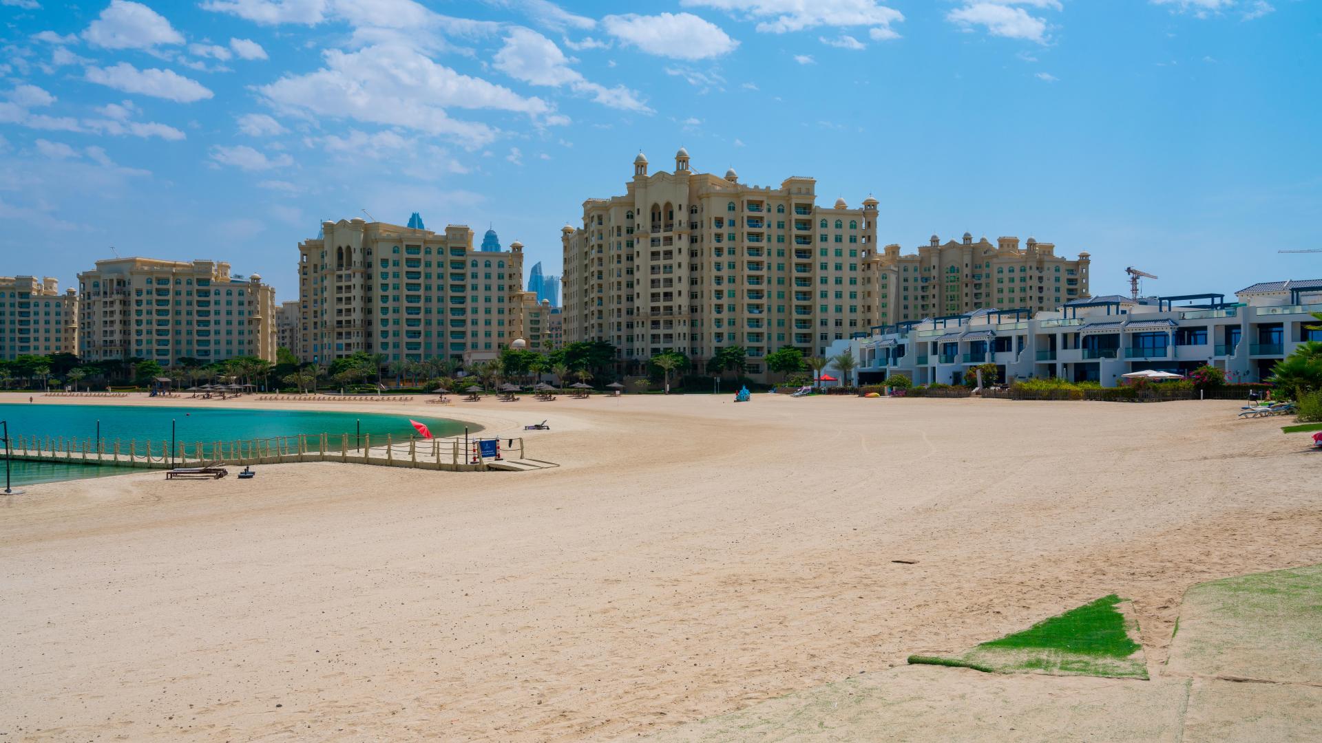 Modern kitchen with wooden cabinets in 5-bedroom Palm Jumeirah villa for sale