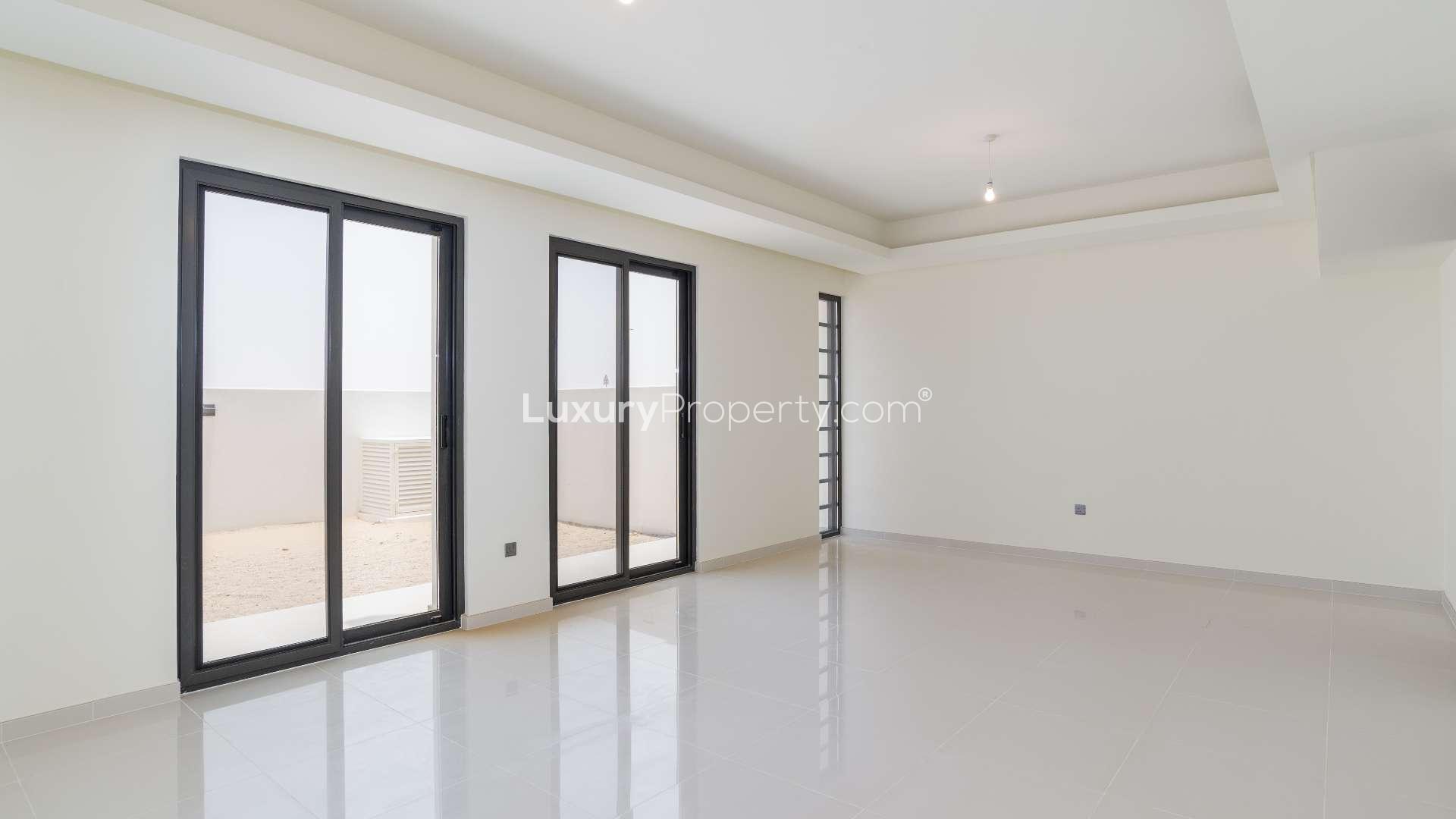 Empty room with large windows in Damac Hills 2 townhouse, Akoya Primrose community