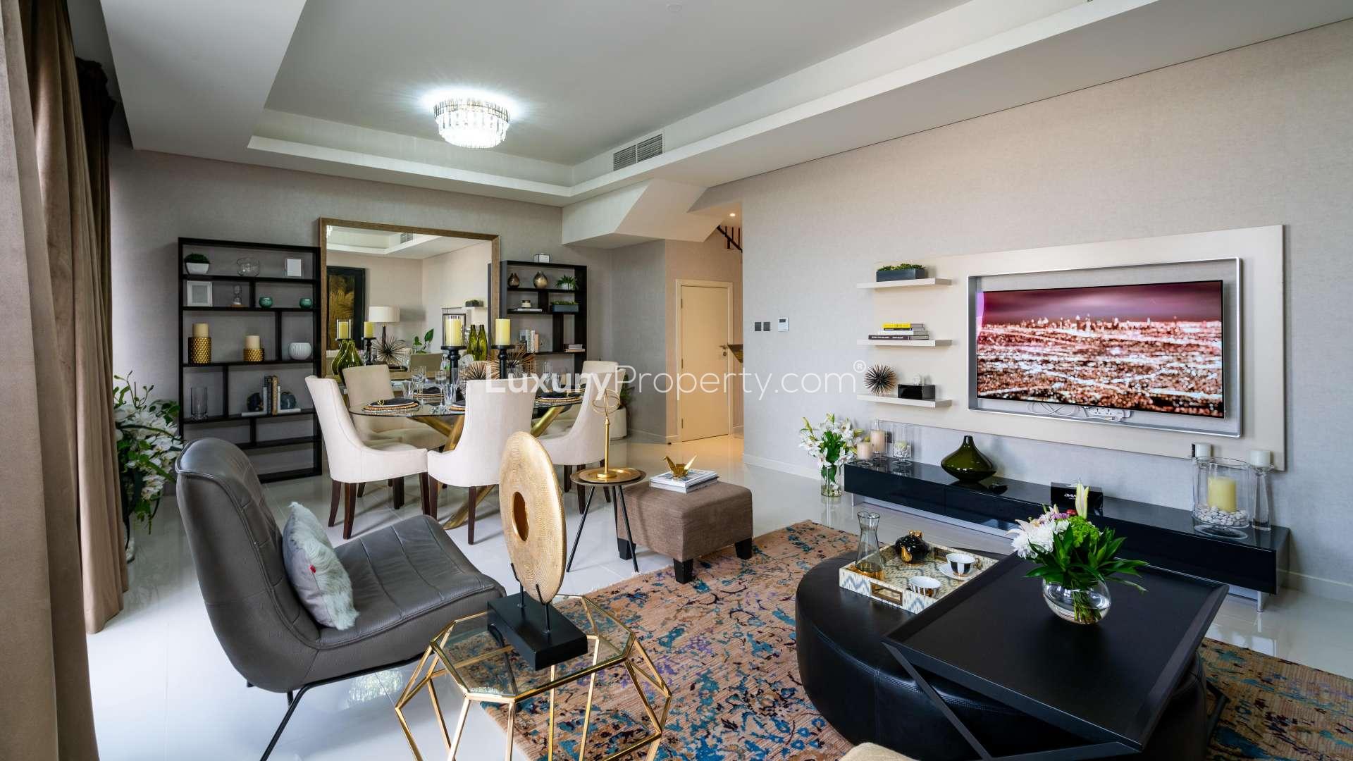 Modern living room in spacious Damac Hills 2 townhouse, featuring elegant decor and comfortable seating