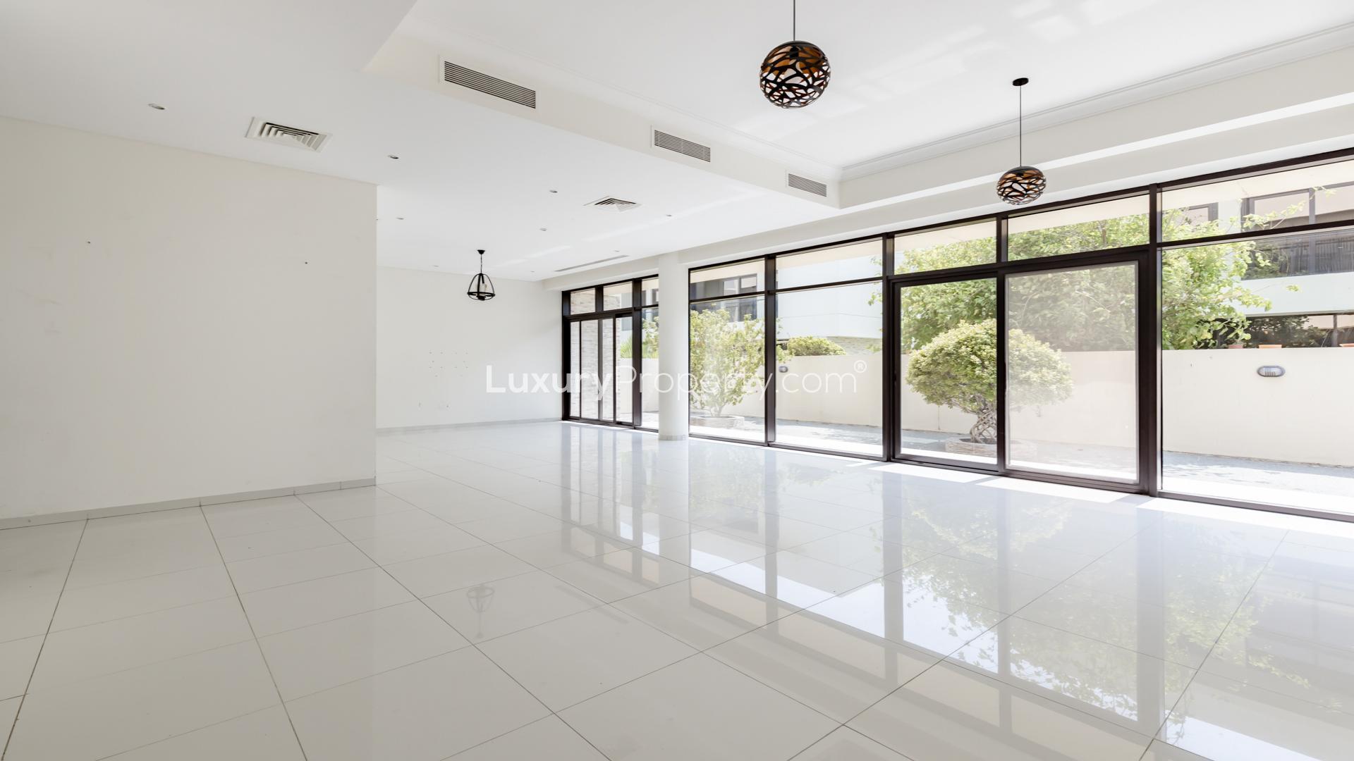 Modern 5-bedroom villa exterior on corner plot in Queens Meadow, Damac Hills. For rent