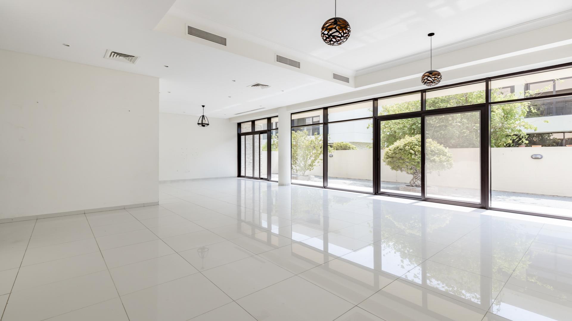 Modern 5-bedroom villa exterior on corner plot in Queens Meadow, Damac Hills. For rent
