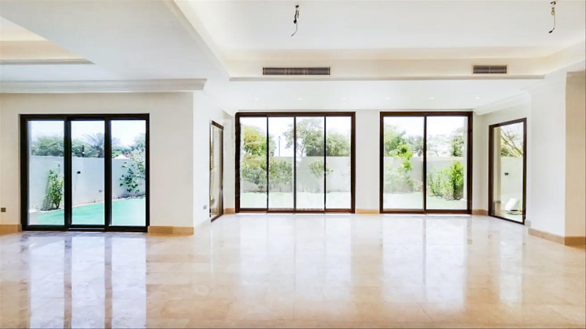 Stunning 5-bedroom villa exterior in Aseel, Arabian Ranches, with lush green lawn