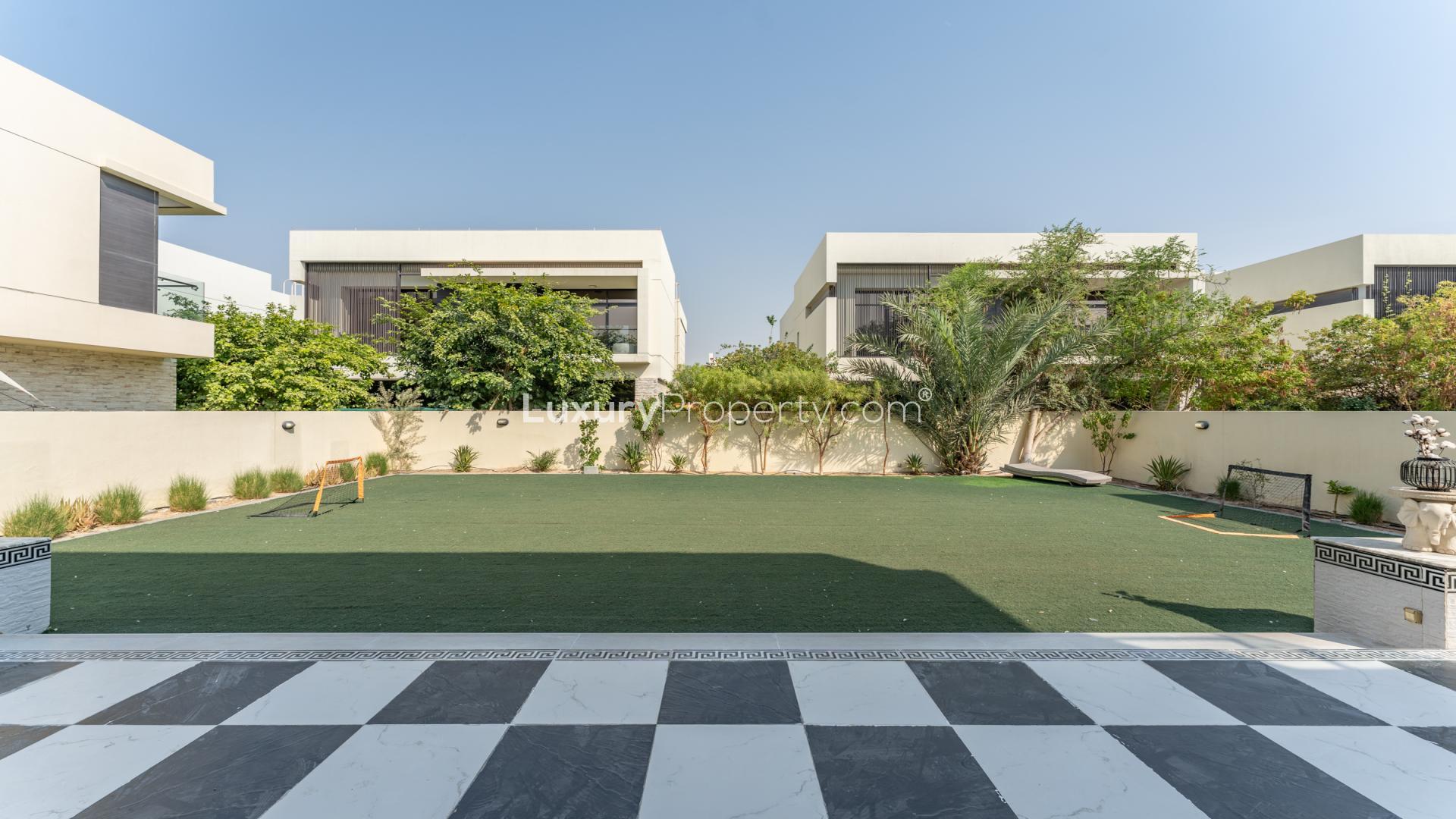 Partially furnished 5-bed villa exterior with spacious lawn in Silver Springs, Damac Hills