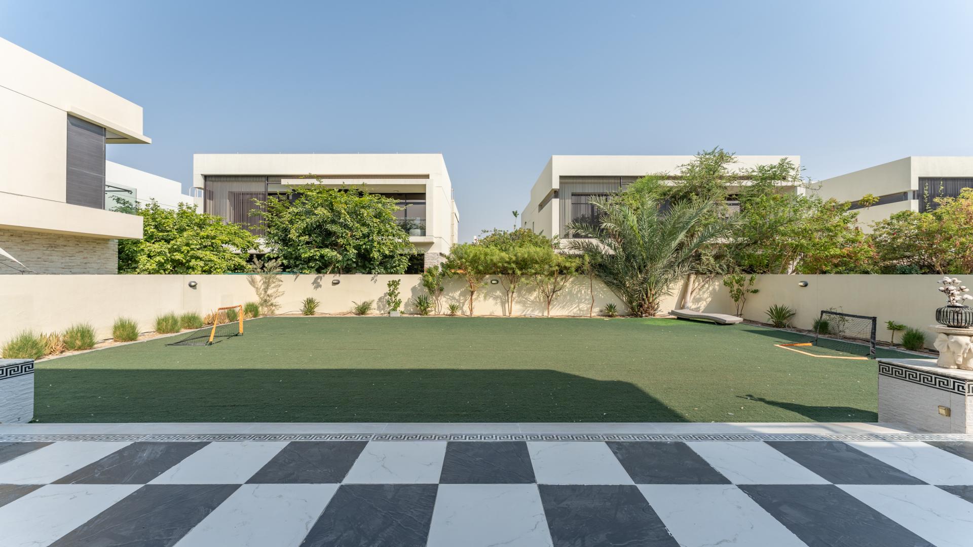 Partially furnished 5-bed villa exterior with spacious lawn in Silver Springs, Damac Hills