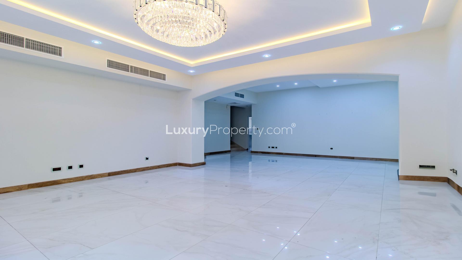Bright living room with chandelier in upgraded Meadows villa, marble floors, large windows