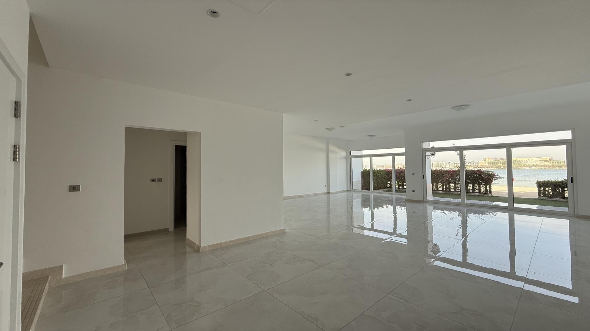 Luxurious villa interior with spacious living area and large windows in Palma Residences