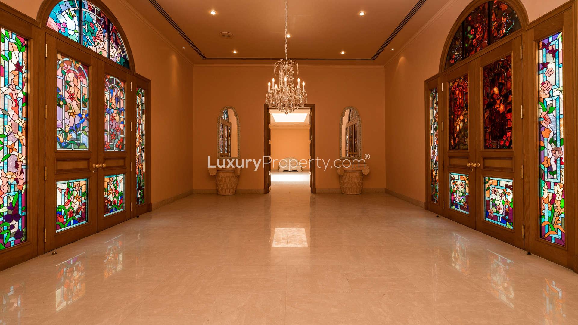 Spacious living area with large windows in Umm Suqeim mansion villa for rent