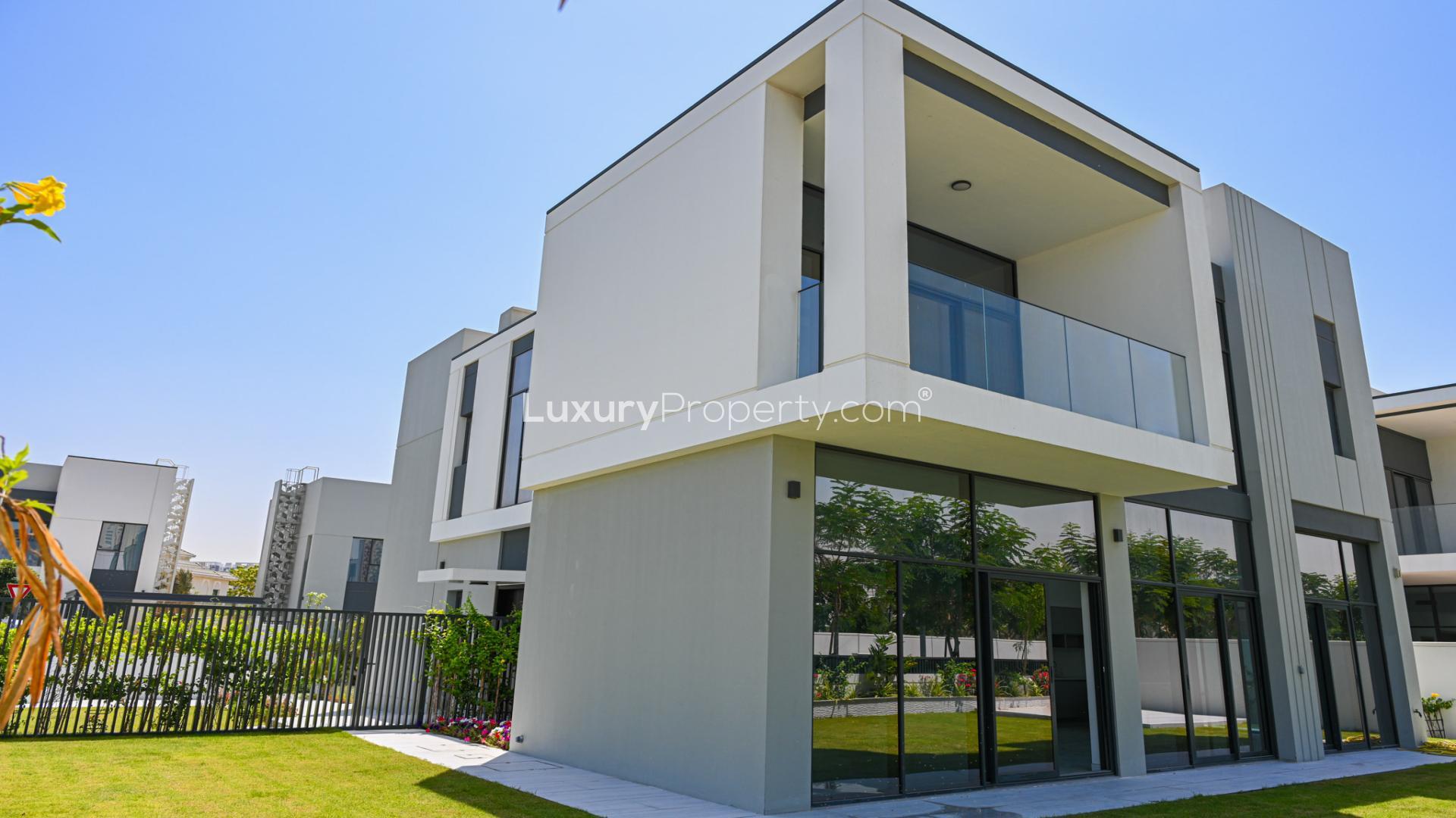 "Spacious living area in Al Furjan villa with modern staircase and large windows.",Corner Villa with private garden in Murooj Al Furjan, available for rent, 5 bedrooms