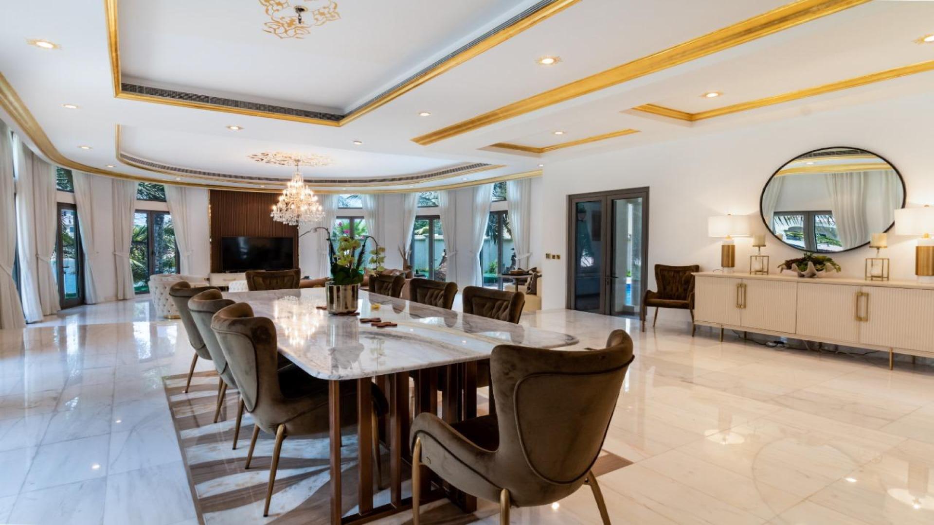 Luxurious living room in 5-bedroom villa, Palm Jumeirah, featuring elegant chandelier and decor