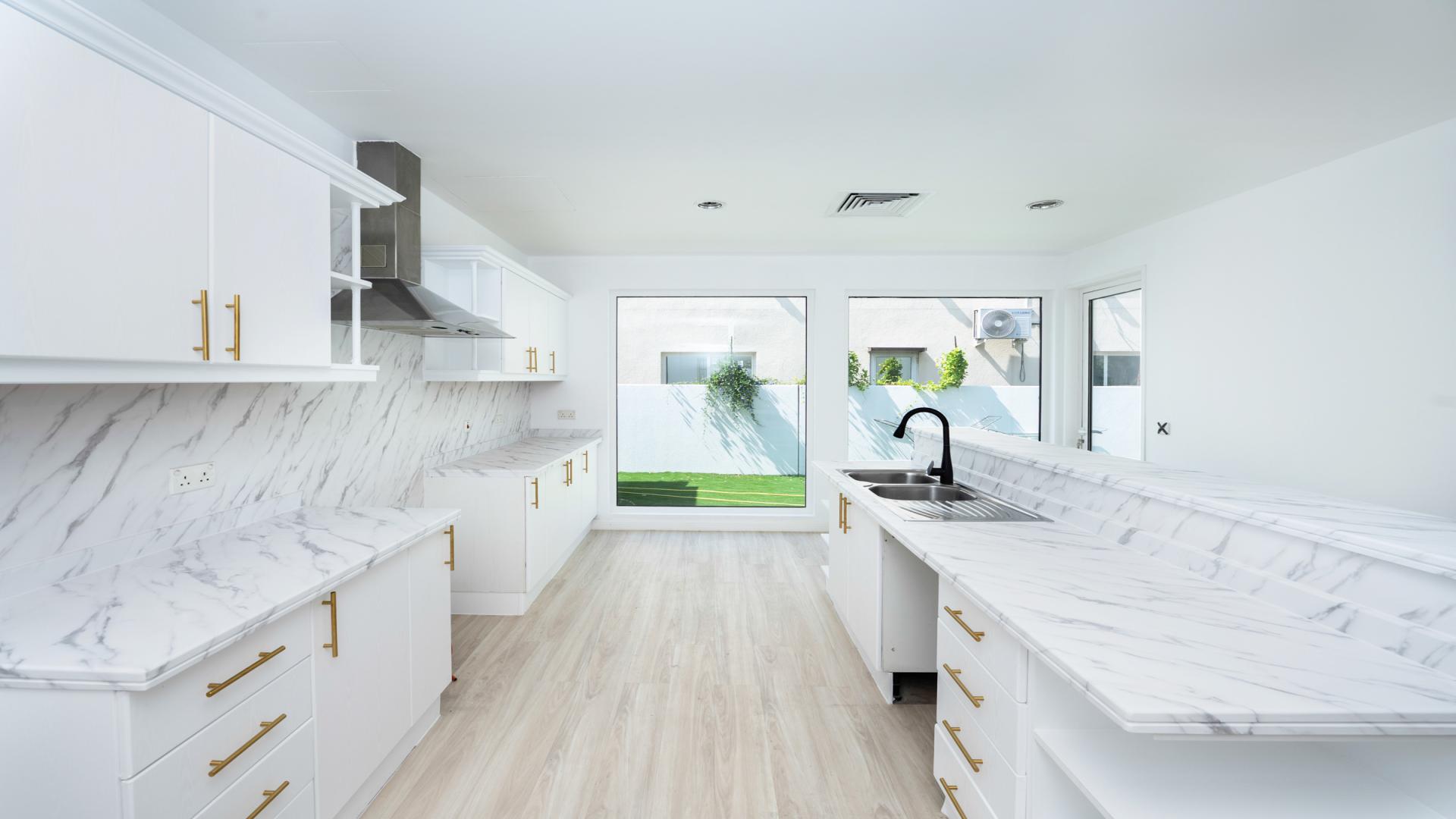 Bright living room with pool view in 5-bedroom villa, Saheel, Arabian Ranches