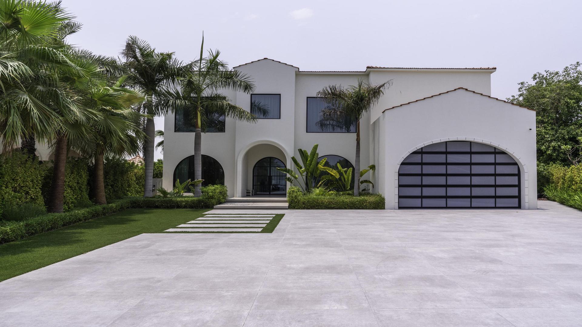 Modern living room in Jumeirah Islands villa with large windows and elegant furnishings