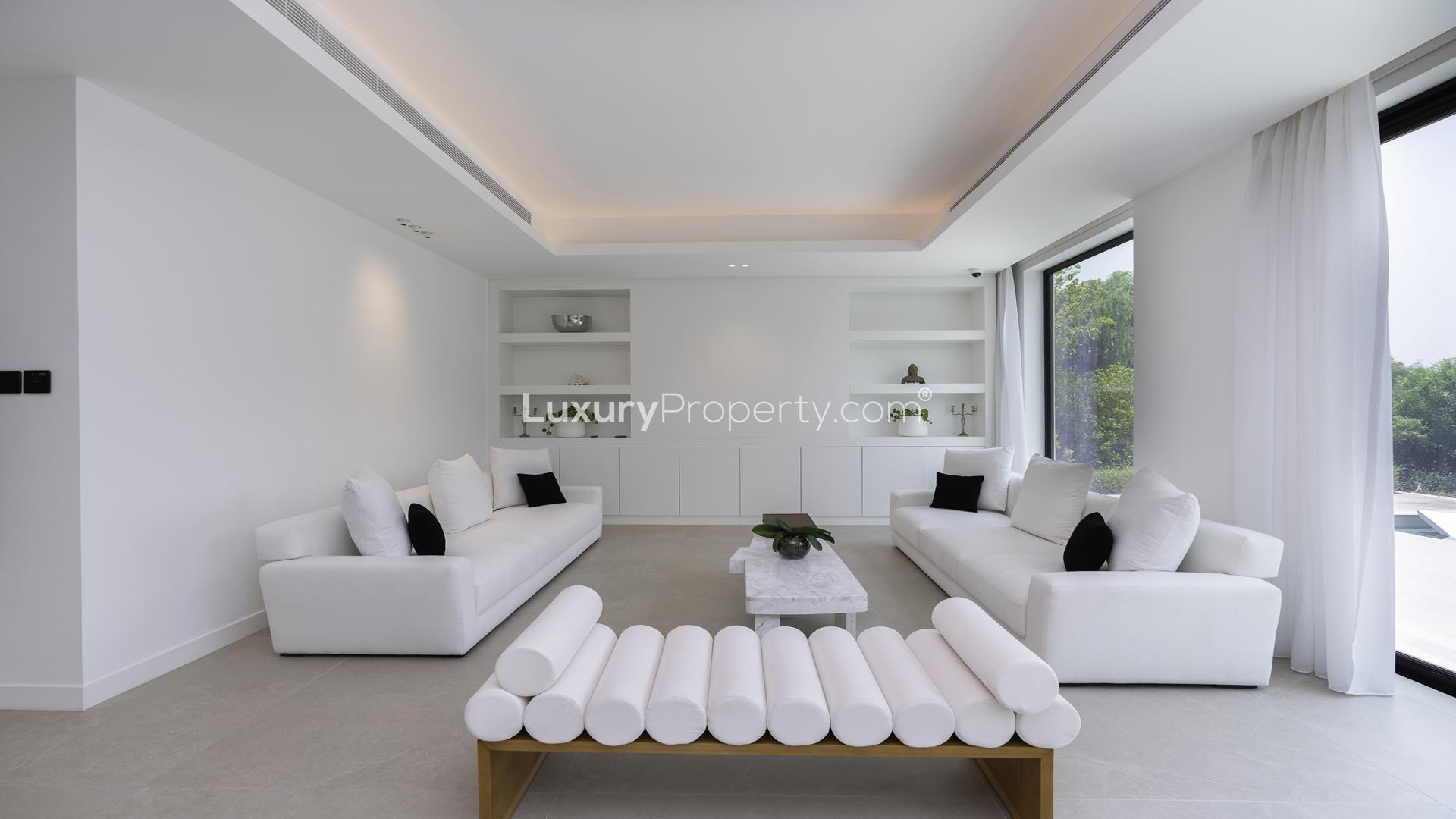 Lake-facing 5-bedroom villa exterior in Jumeirah Islands, Mediterranean Clusters, with lush greenery