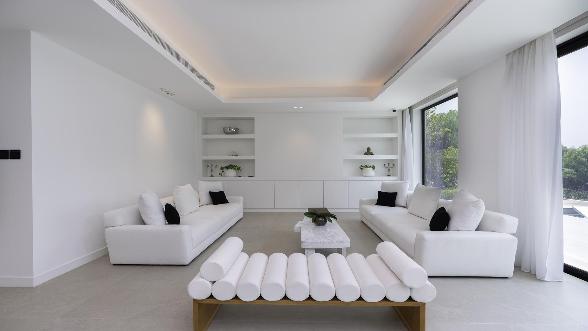 Lake-facing 5-bedroom villa exterior in Jumeirah Islands, Mediterranean Clusters, with lush greenery