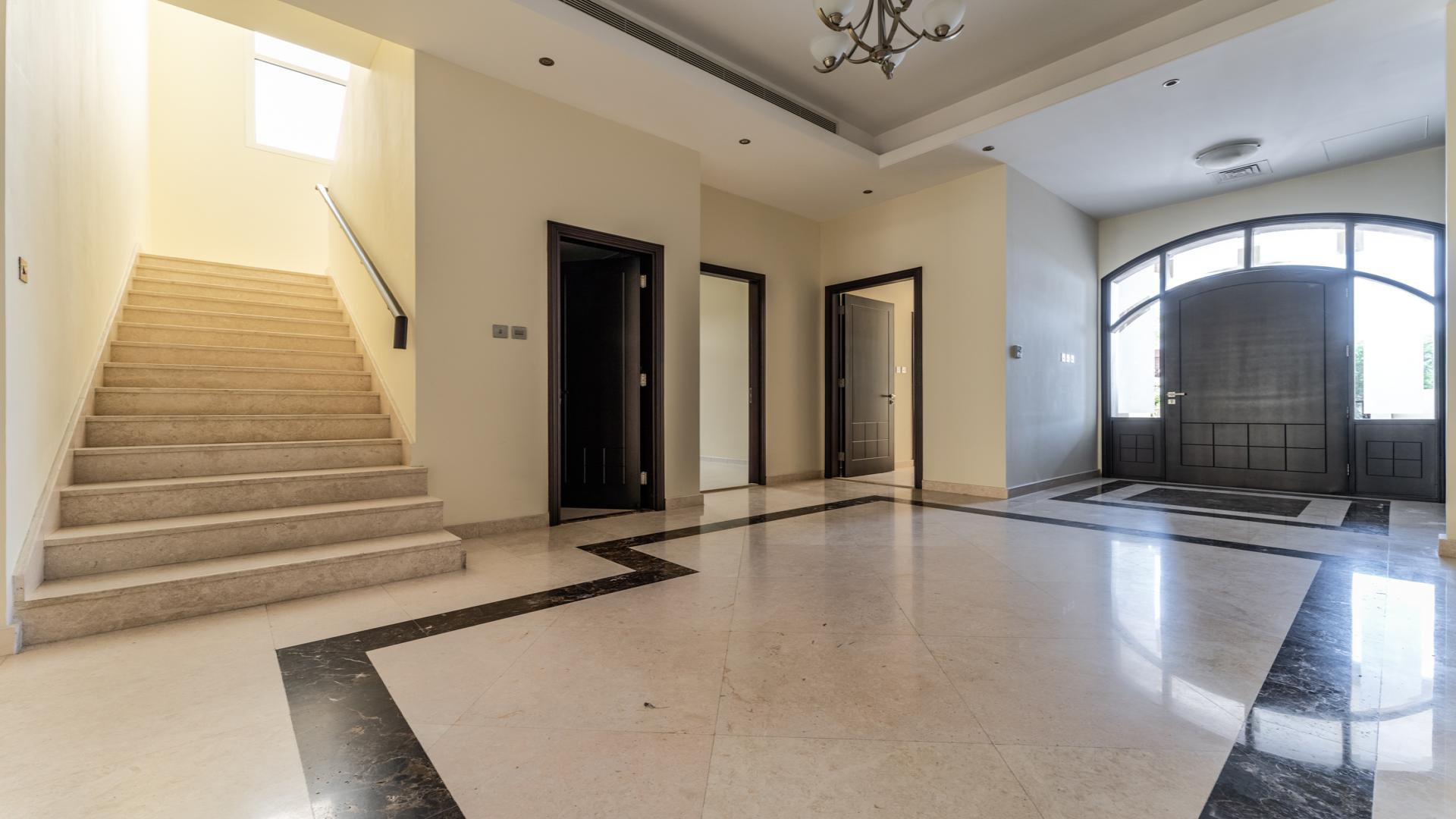 Spacious living room in elegant Umm Al Sheif villa with modern design and marble flooring