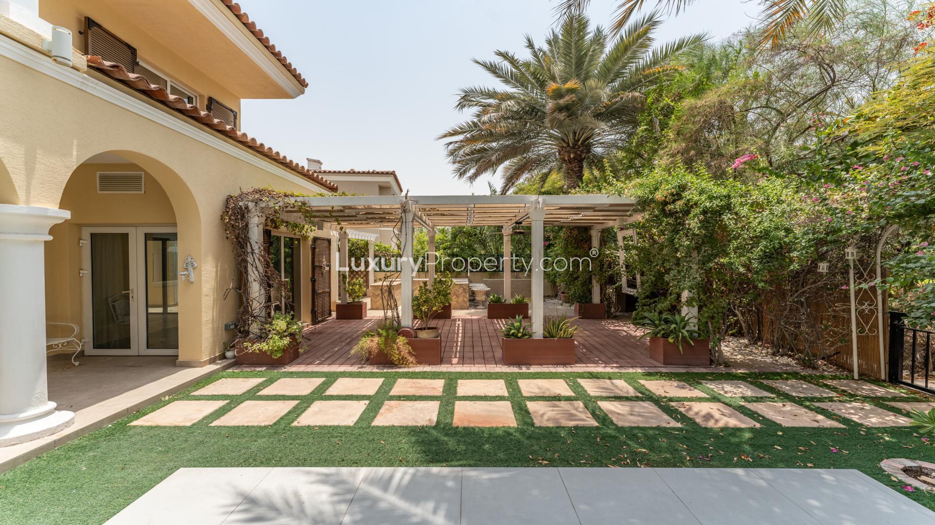 "Elegant villa patio with columns and garden view in Green Community West, Dubai.",Exquisite villa garden with pergola in Green Community West, Dubai, for rent