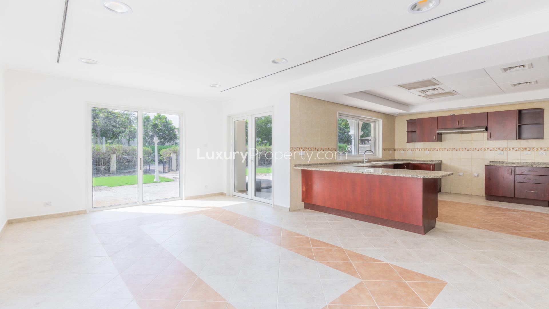 Luxurious 5-bedroom villa exterior in Green Community West, featuring lush greenery and driveway