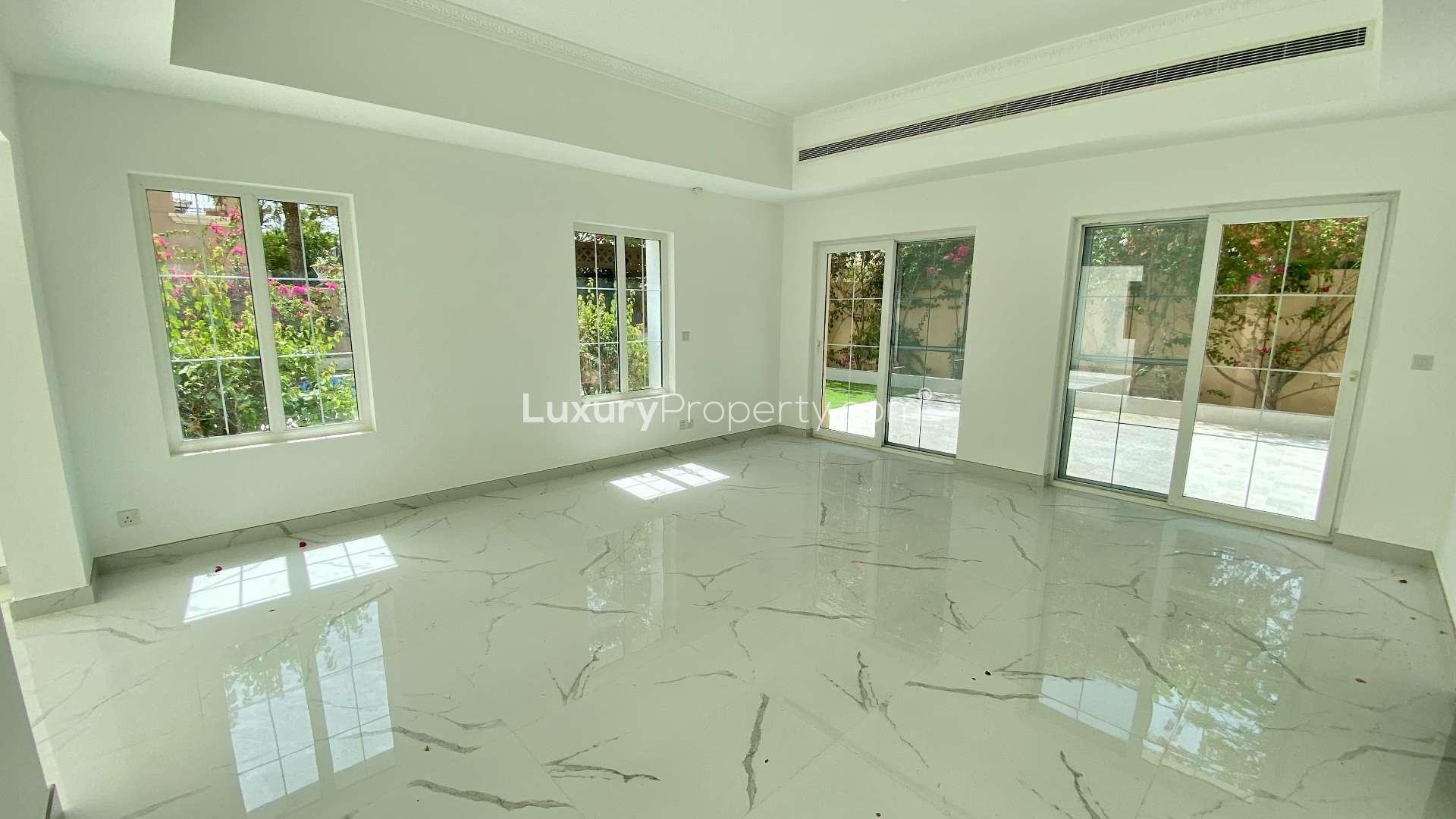 Spacious living room with marble floors and pool view in Alvorada villa, Arabian Ranches