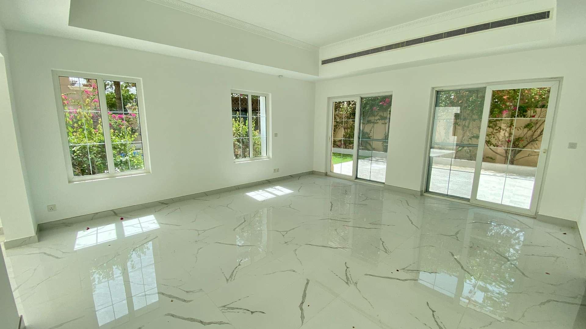 Spacious living room with marble floors and pool view in Alvorada villa, Arabian Ranches