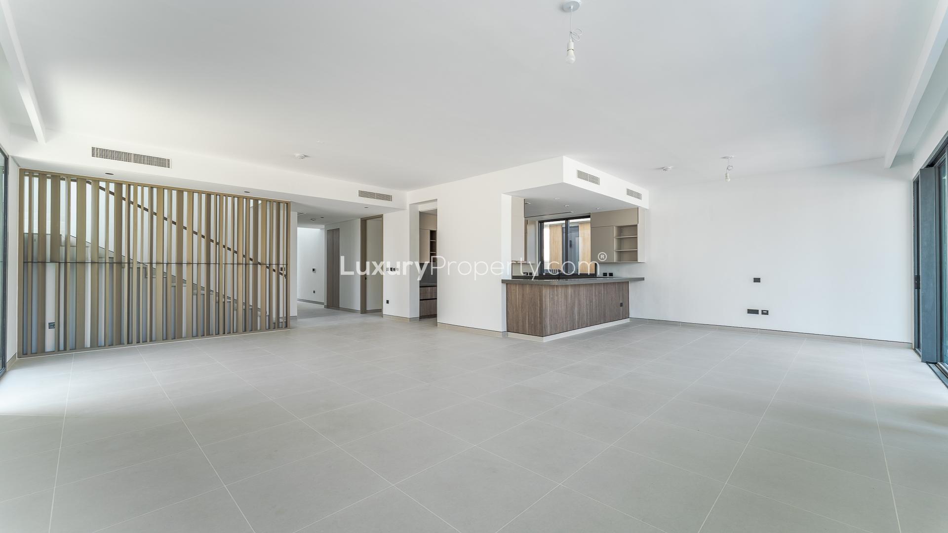 Outdoor patio with dining area overlooking pool at 5-bedroom villa in Harmony 2, Tilal Al Ghaf