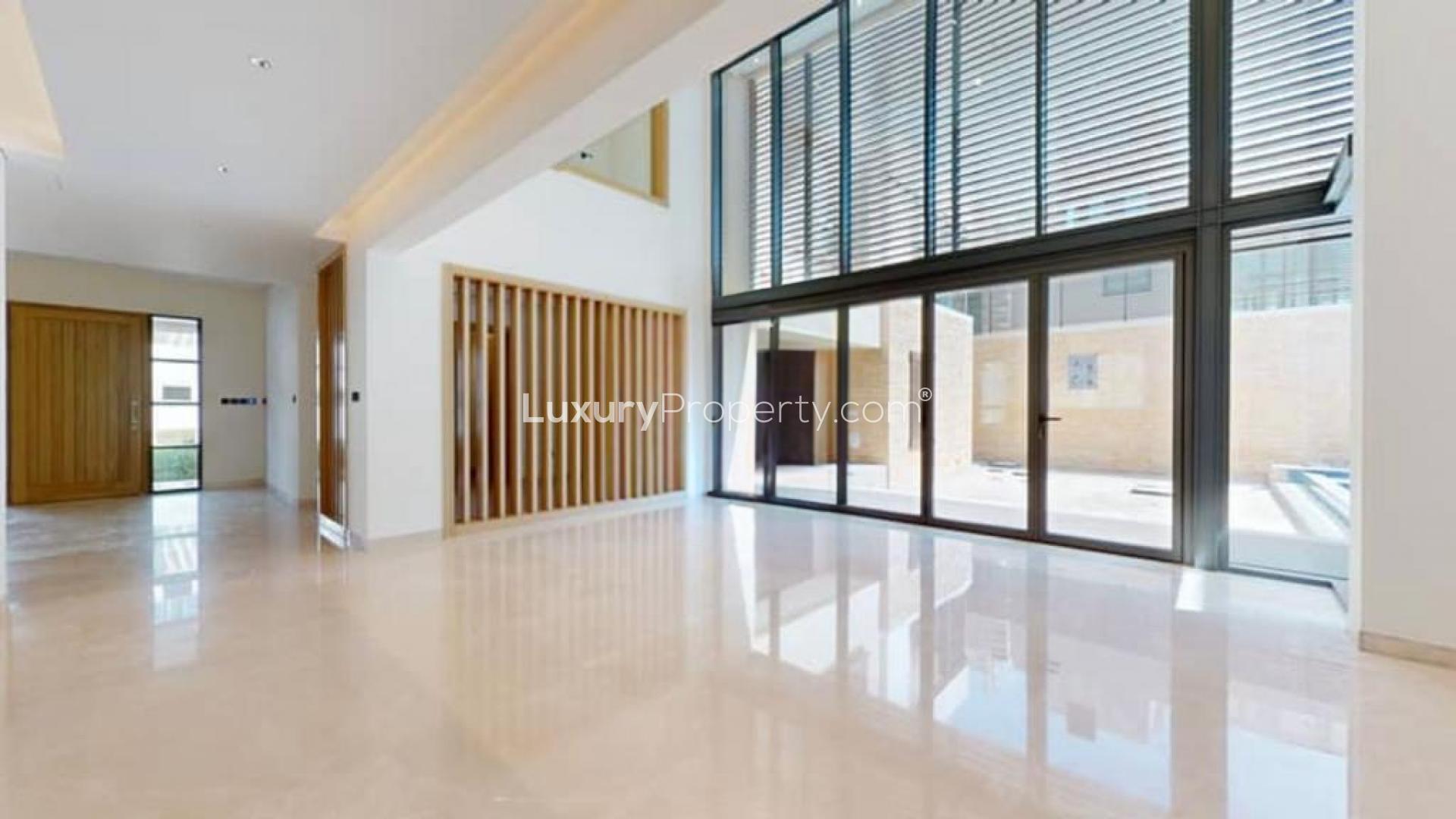 Modern villa exterior with large windows and pool in Sobha Hartland, Mohammed Bin Rashid City