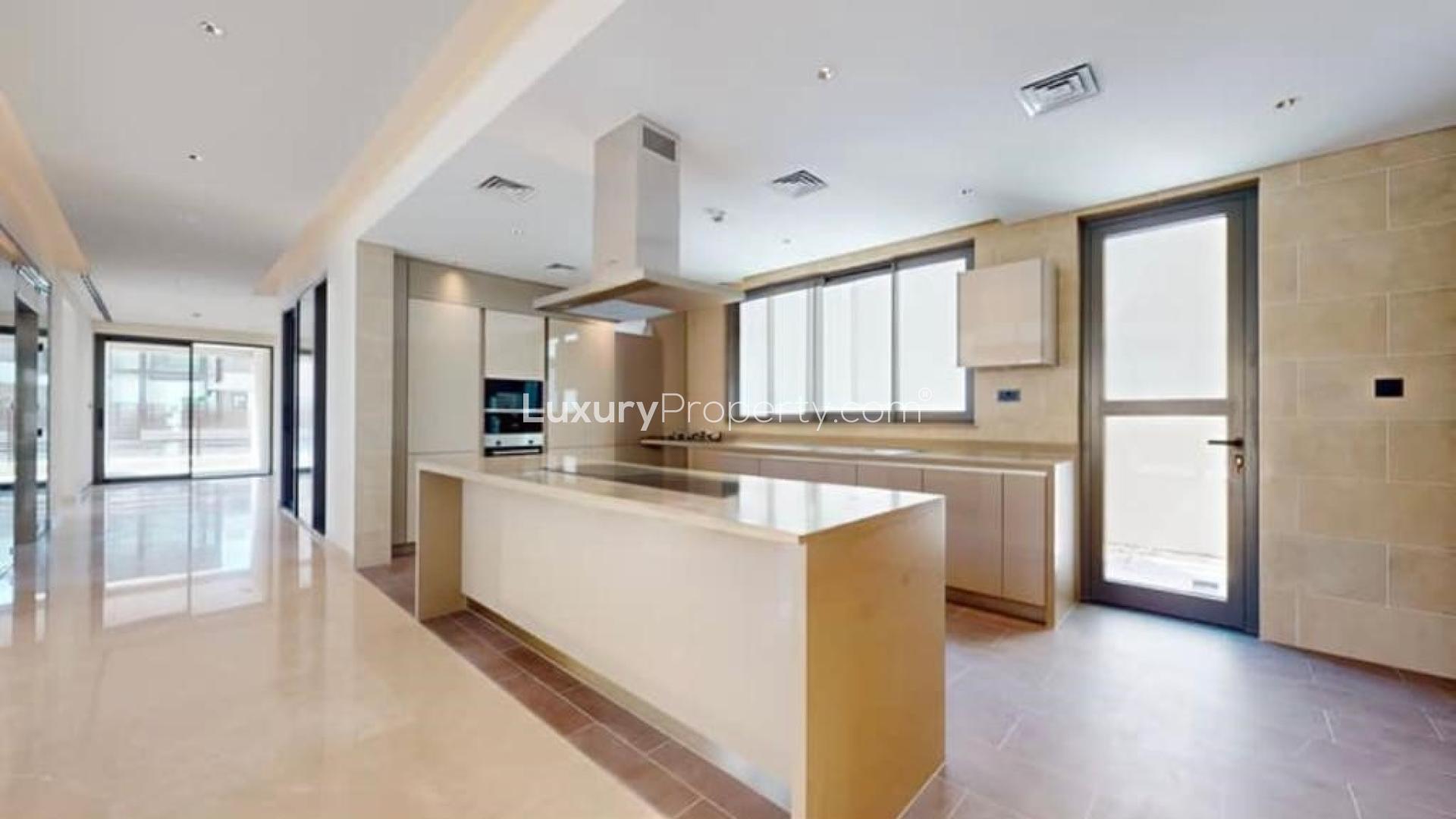 "Spacious living area in Sobha Hartland 5-bedroom villa with large windows and modern design.",Modern kitchen in brand new 5-bedroom villa, Sobha Hartland, Mohammed Bin Rashid City