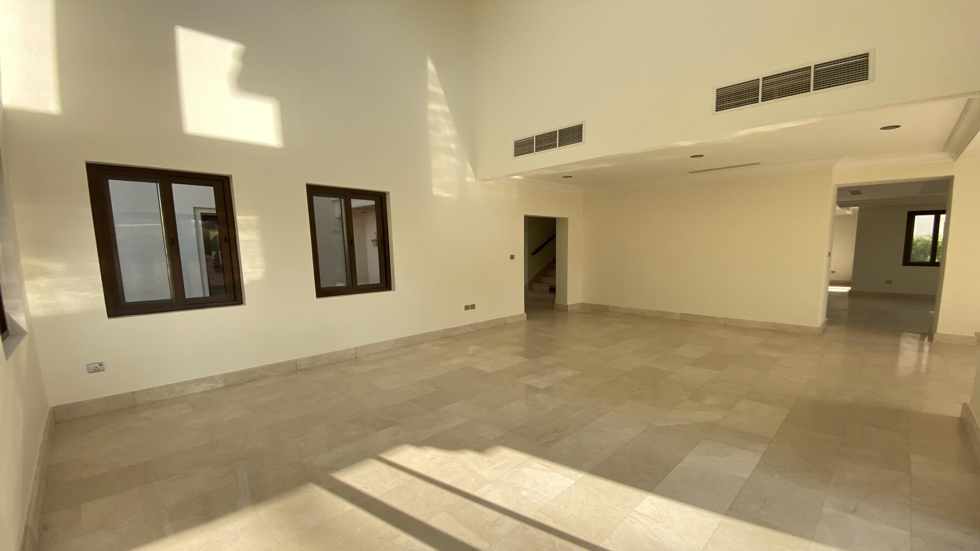 Spacious living room with large windows in modern 6-bedroom villa, Arabian Ranches, Aseel