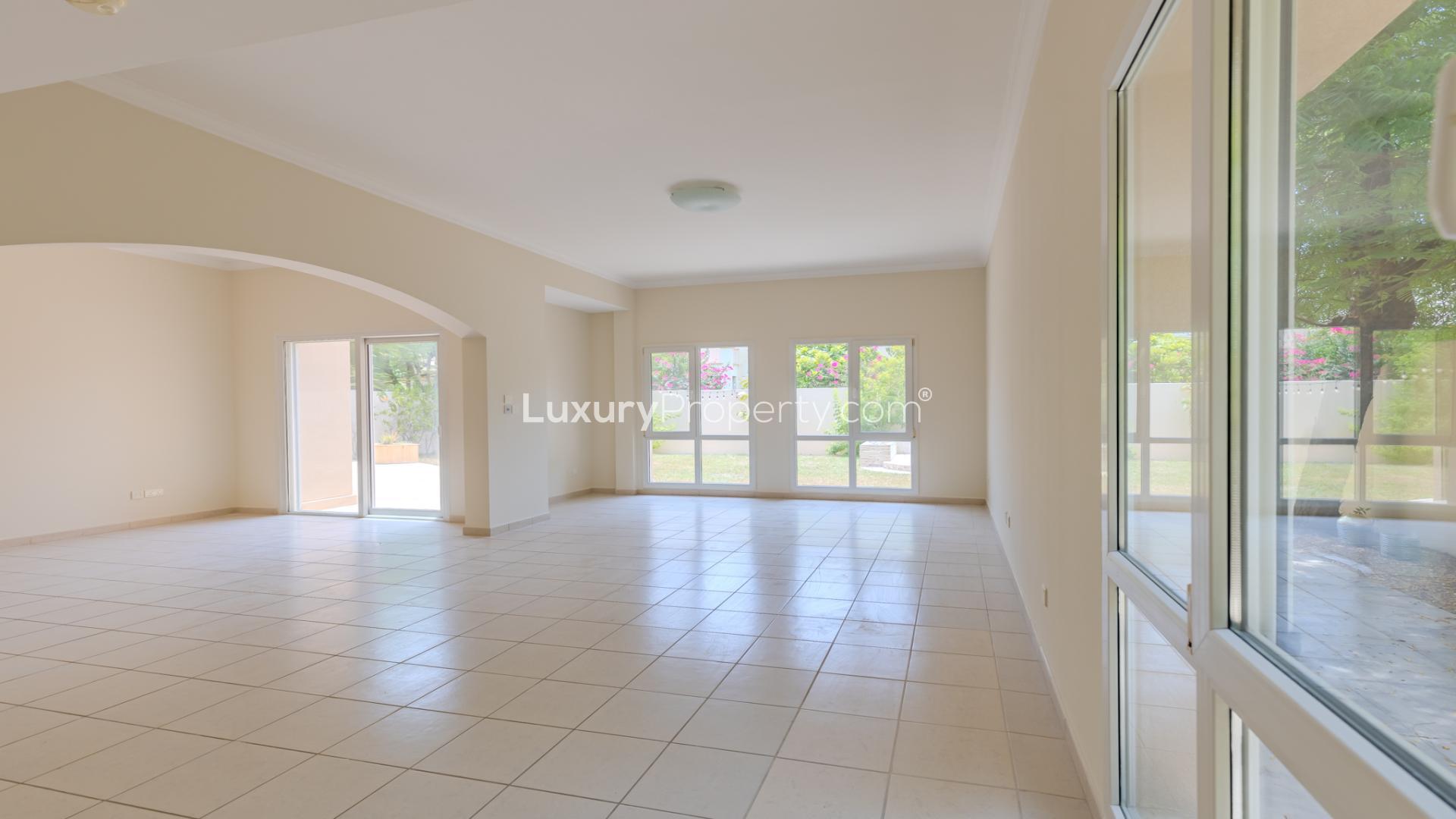 Modern villa exterior with spacious garden in Meadows 8, perfect for family living