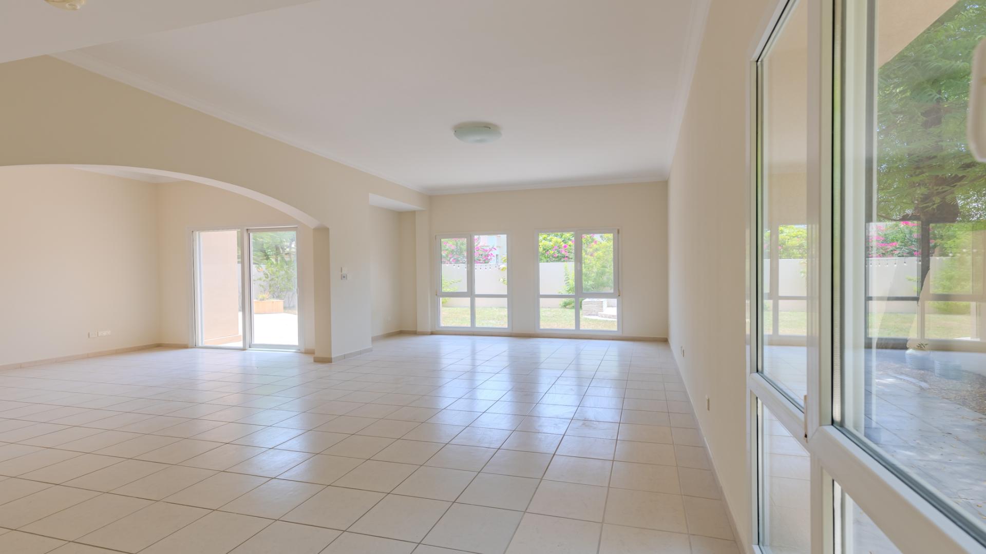 Modern villa exterior with spacious garden in Meadows 8, perfect for family living