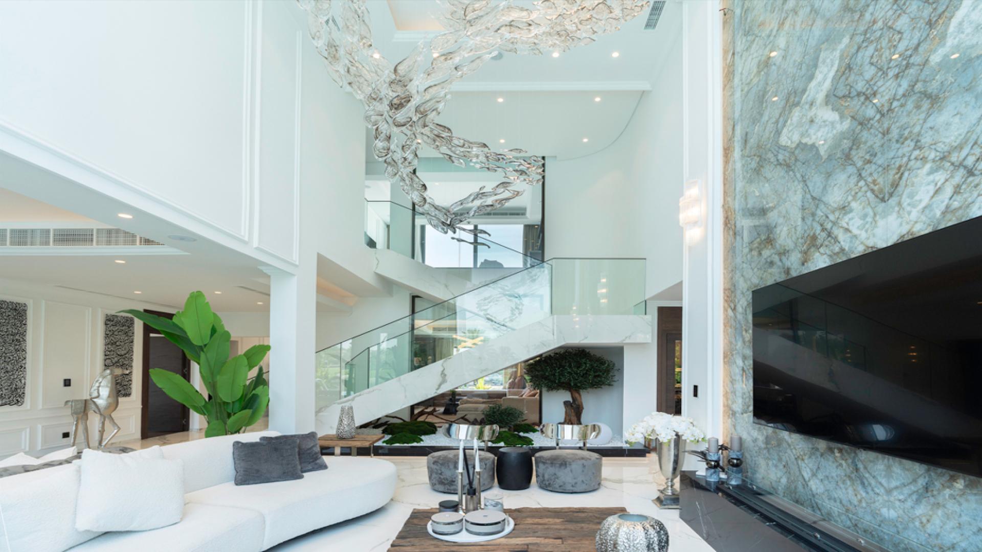 Luxurious living room in European Clusters villa with plush sofas and lake view